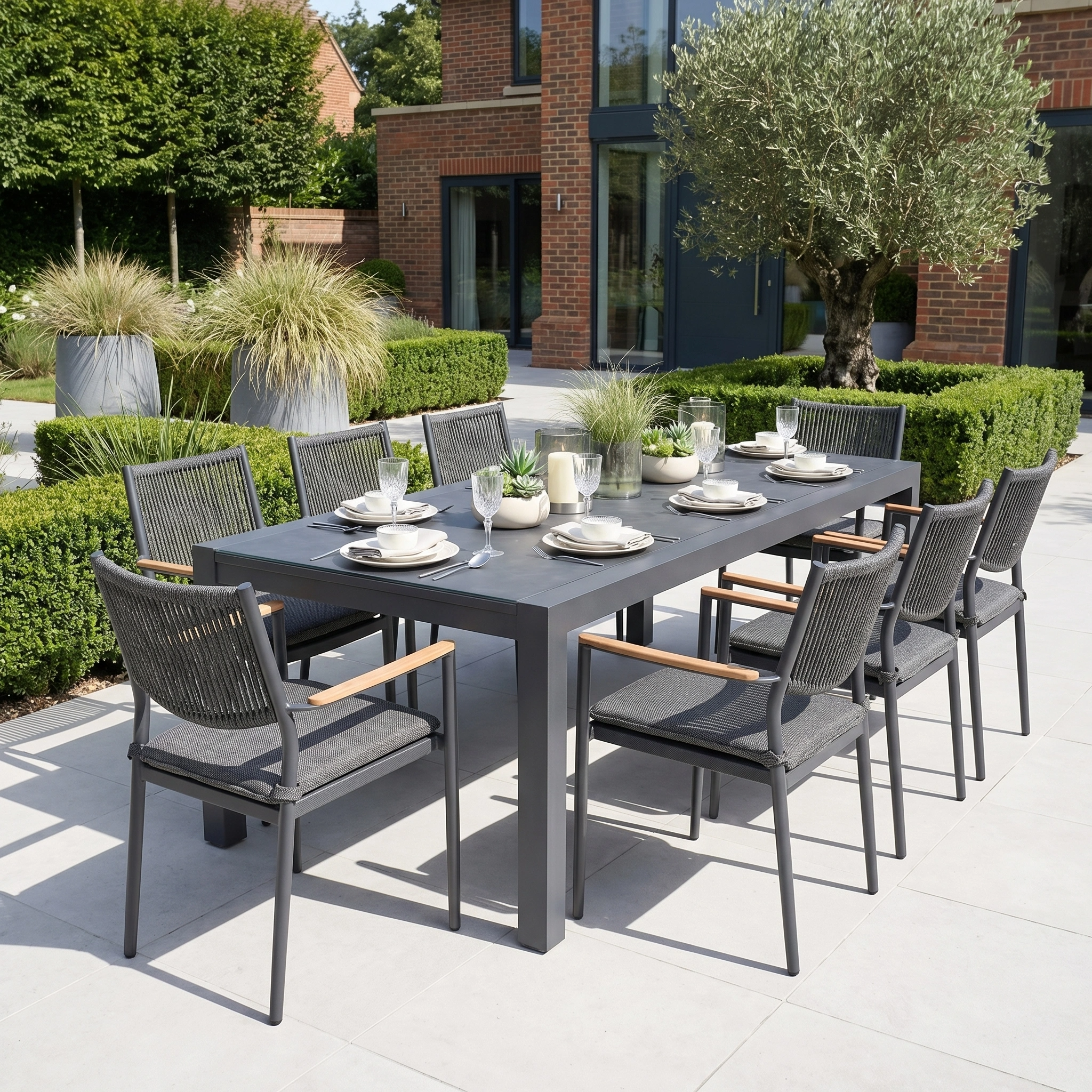 The Tellaro 8 Seat Extending Dining Set with Ceramic Table in Grey features a durable aluminium frame and comes with eight chairs, ideal for stylish outdoor dining on your patio or garden.
