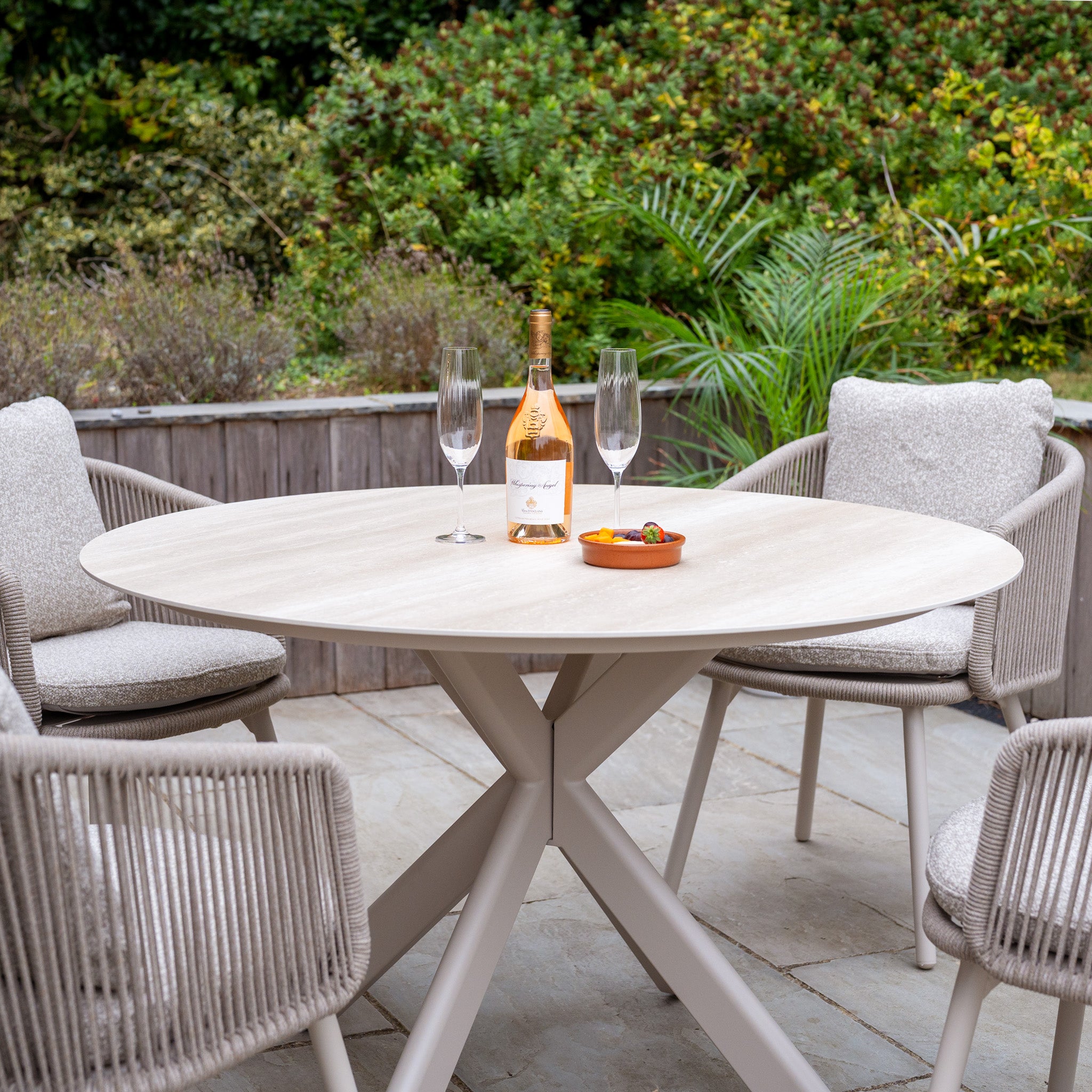 The Theia 4 Seat Round Rope Dining Set with Albatross Table in Oatmeal features a round table and four chairs—ideal for stylish, comfortable outdoor dining and relaxing evenings al fresco.