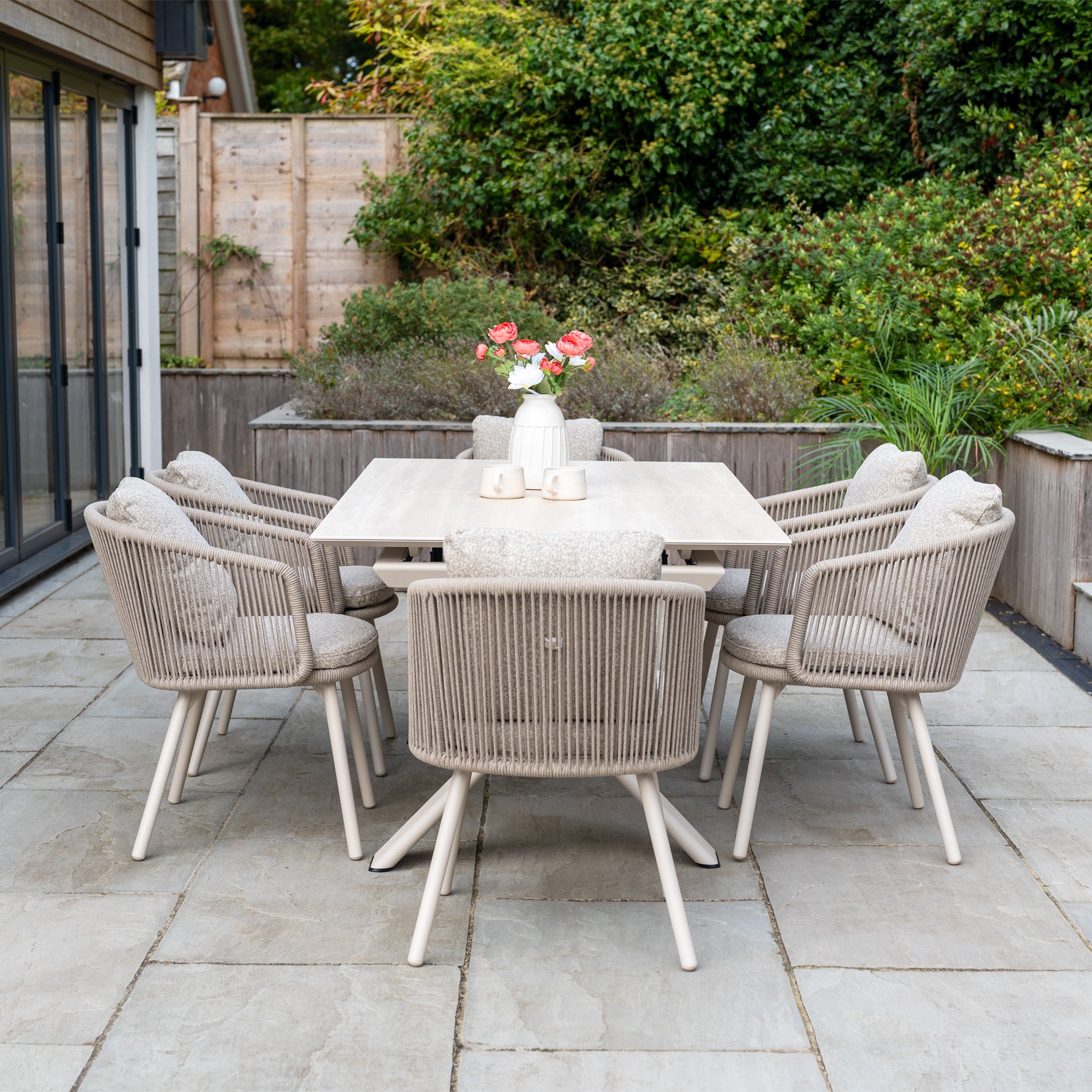 Theia 6 Seat Rope Dining Set in Oatmeal features six cushioned chairs and a stylish Albatross Extending Table, perfect for outdoor dining and gatherings.