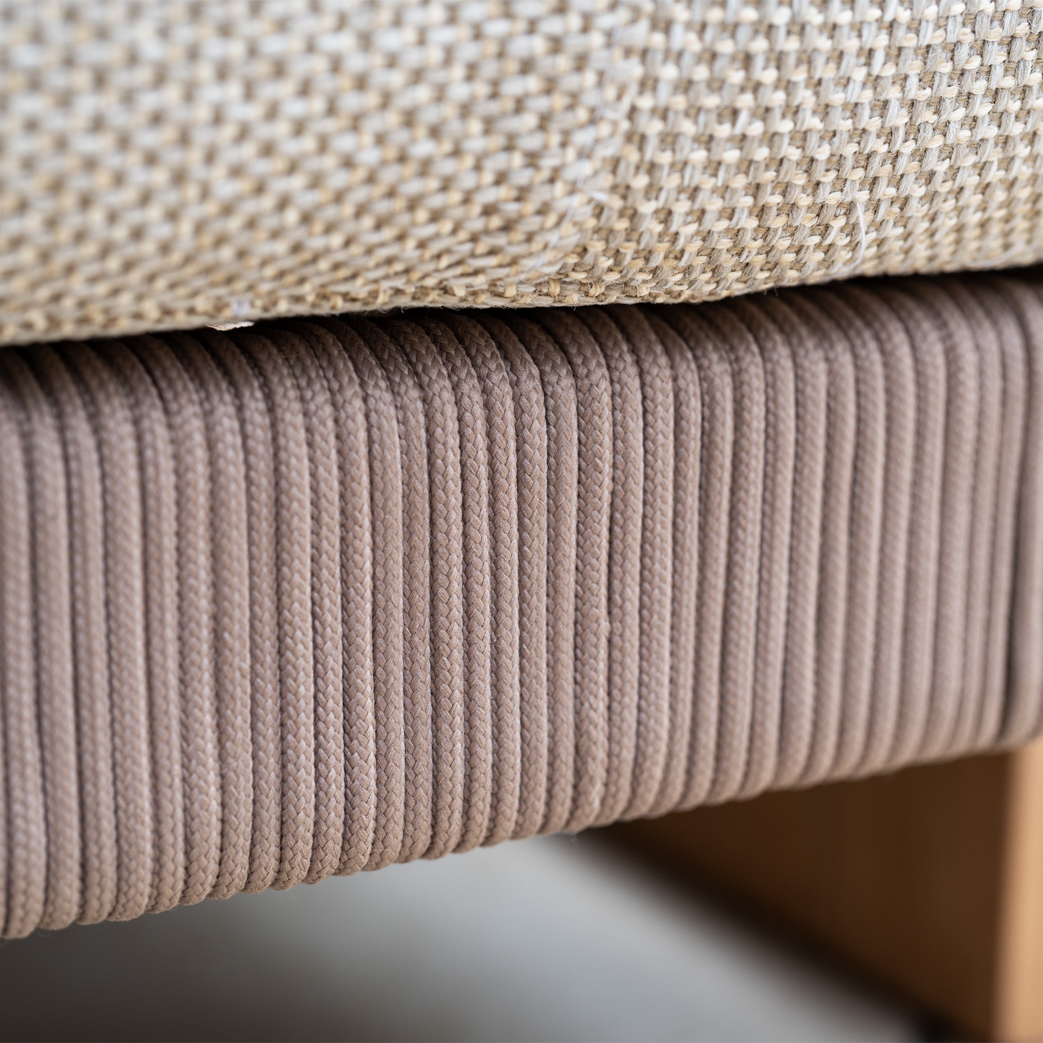 Close-up of a beige woven fabric cushion on a ribbed brown base with wooden legs, perfectly paired with the Tivoli 3 Seat Sofa Set with Marble Coffee Table in Fawn.