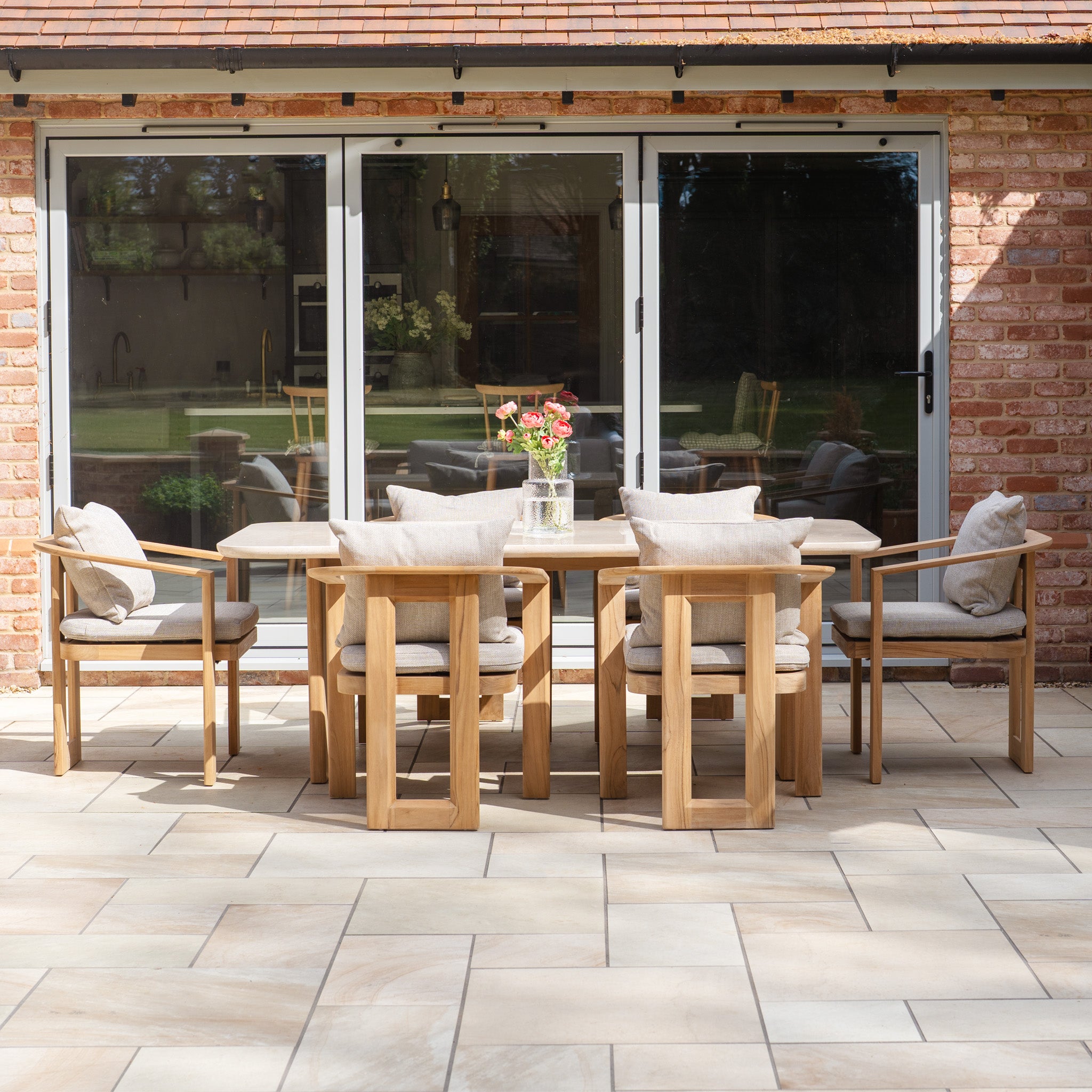 The Tivoli 6 Seat Dining Set with Marble Dining Table in Fawn features six cushioned chairs and a modern design, perfect for outdoor dining on your patio.