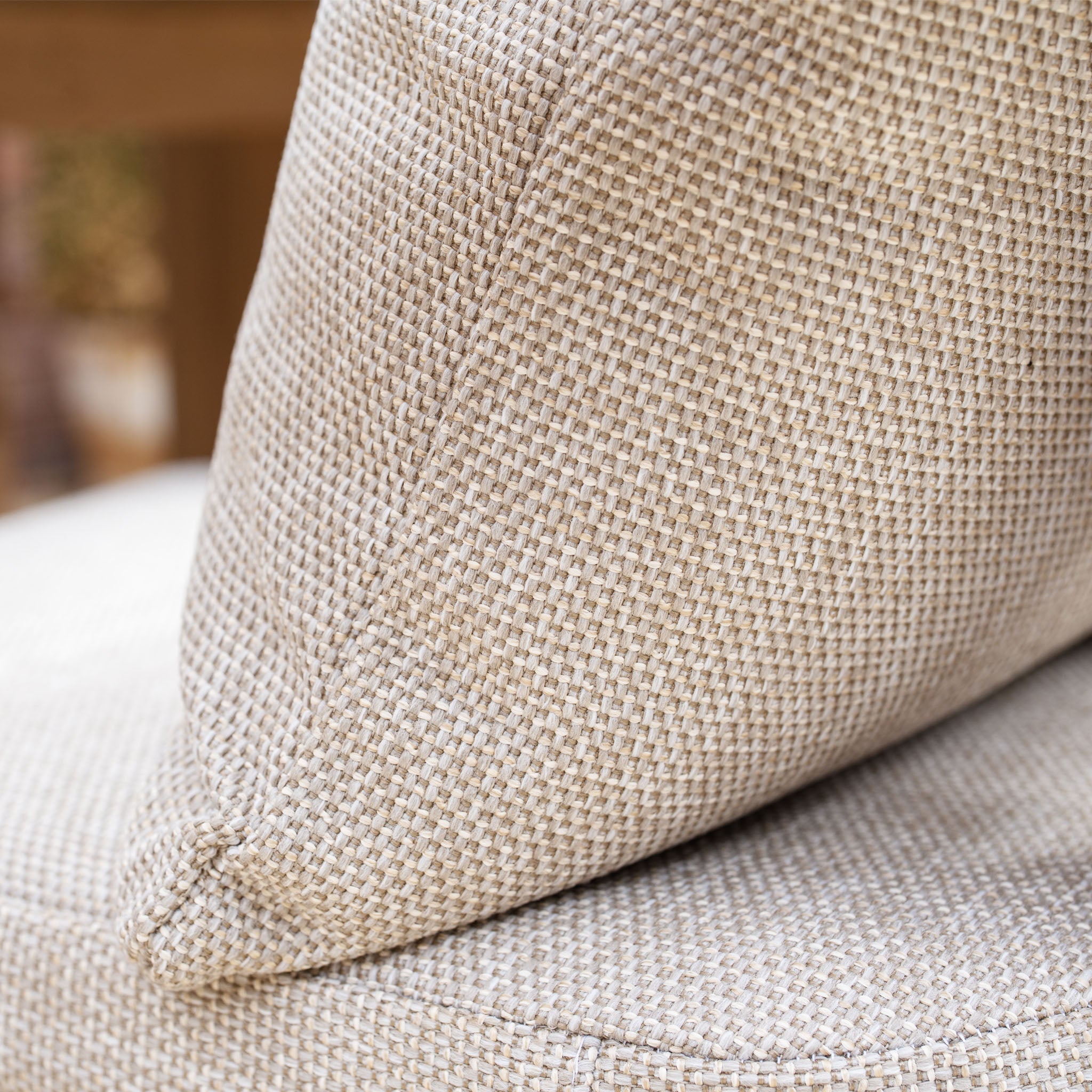 Close-up of a beige textured fabric cushion with a visible woven pattern, ideal for pairing with the Tivoli 6 Seat Dining Set with Marble Dining Table in Fawn.