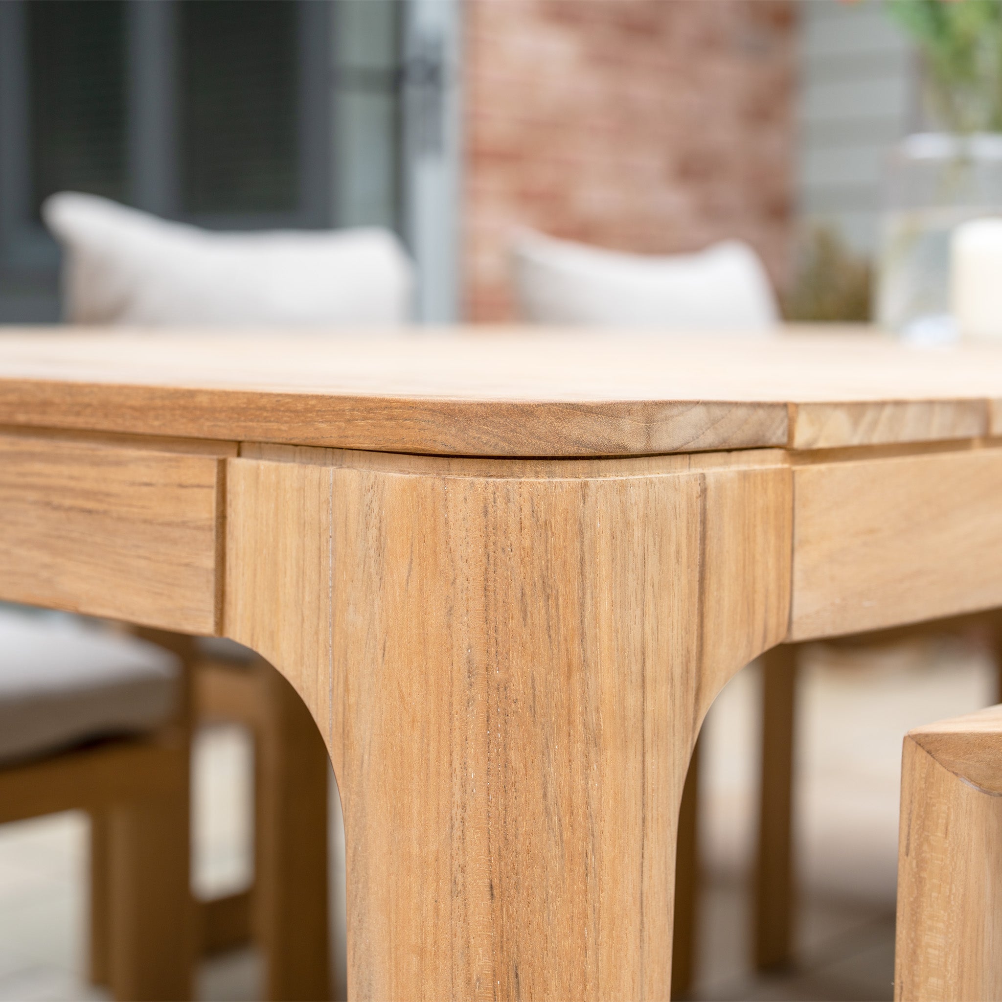 Close-up of the Tivoli 8 Seat Dining Set with Teak Dining Table in Fawn, shown on a patio with matching chairs and UV resistant cushions for long-lasting comfort.