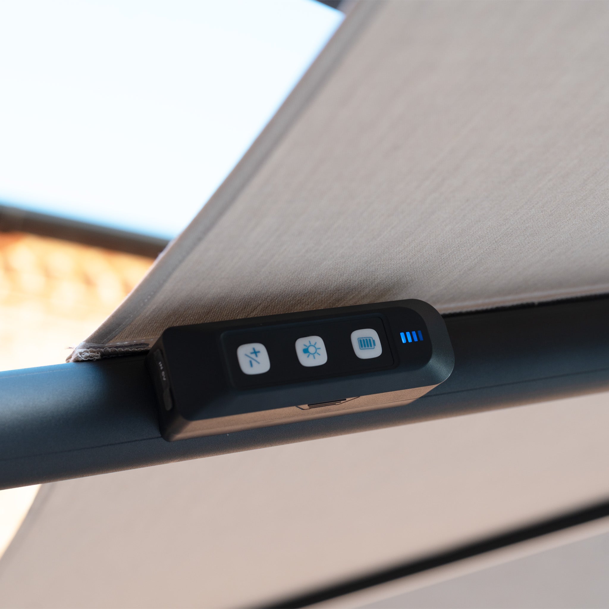 Close-up of the Volos 3m x 3m Square Cantilever Parasol in Wheat, featuring a remote control with three buttons and LED indicators, UV resistant canopy, integrated LED lighting, and a sturdy 120kg granite base.