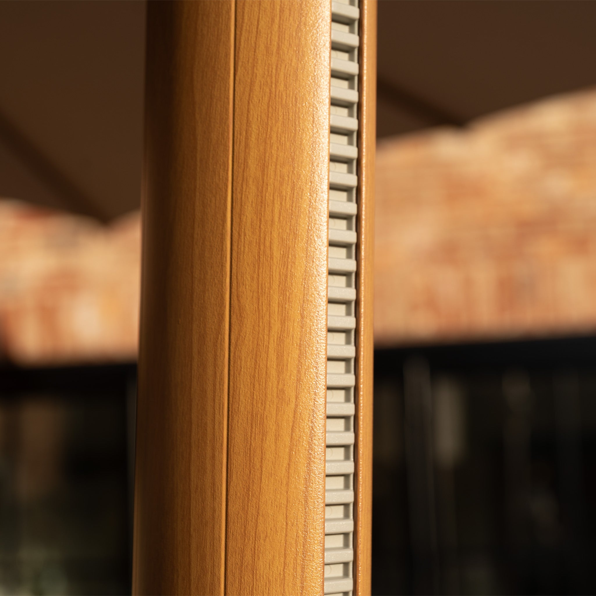 Close-up of the Volos 3m x 4m Rectangular Cantilever Parasol in Wheat and Wood Effect, featuring a wooden pole design with a vertical row of gray rectangular LED lighting controls on its 120kg granite base.