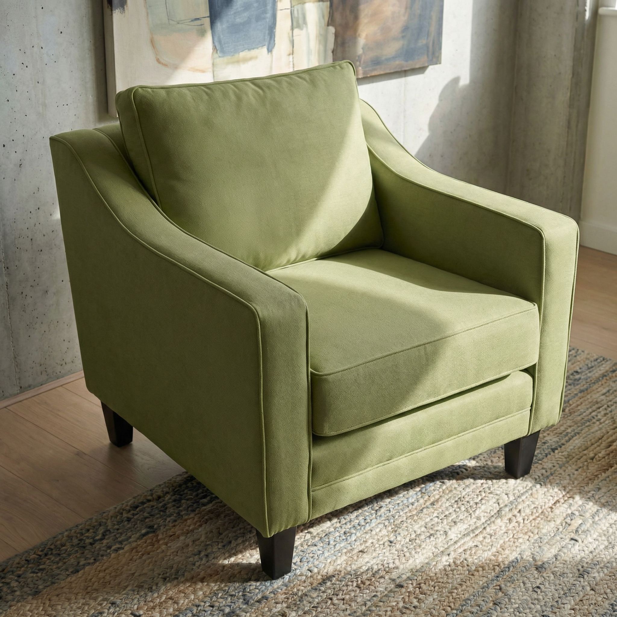 The Wiltshire Armchair in Olive, featuring green upholstery and dark FSC-certified wood legs, sits on a woven rug in a sunlit room.