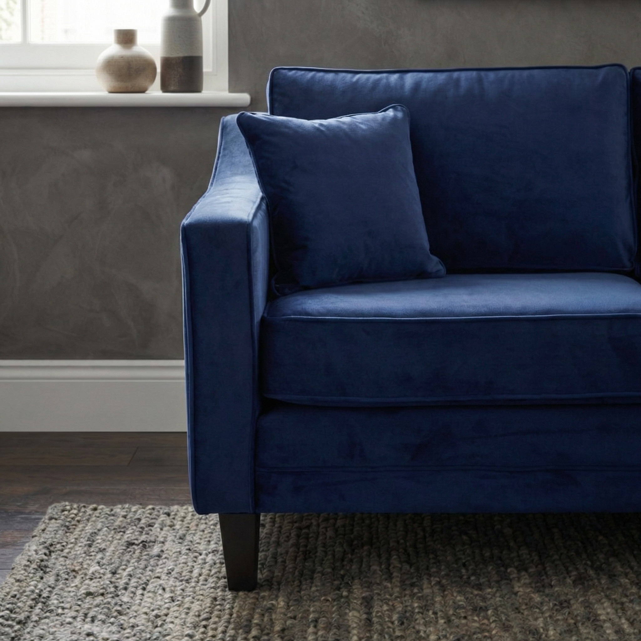 Close-up of the Wiltshire 2 Seat Velvet Sofa in Royal Blue, featuring a plush texture, thrown pillow, and timeless handcrafted details.