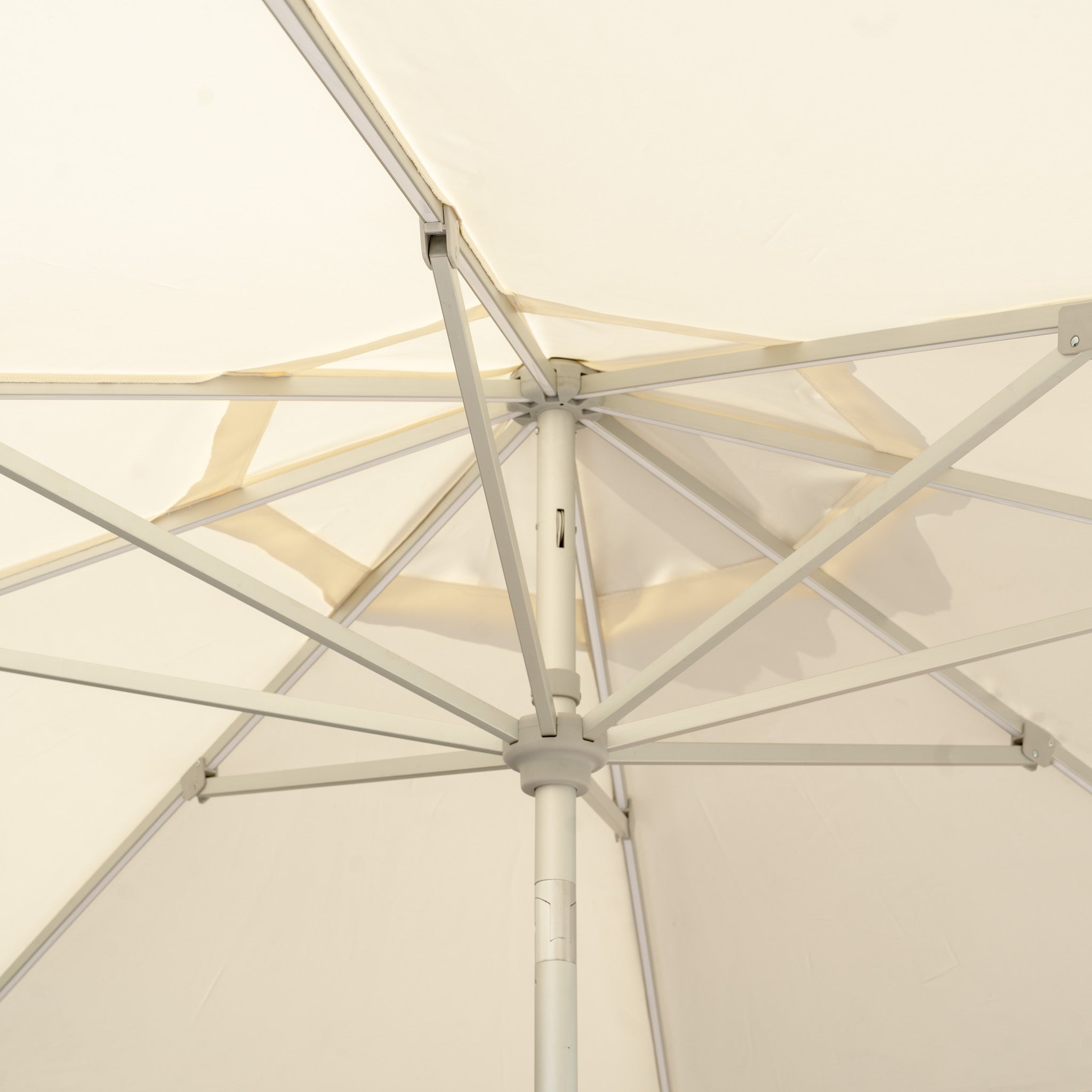Underneath view of a Zelos 2.5M Round Parasol with LED Lighting in Cream, showcasing its sturdy metal ribs and UV-protective fabric, ideal for enhancing outdoor living experiences.