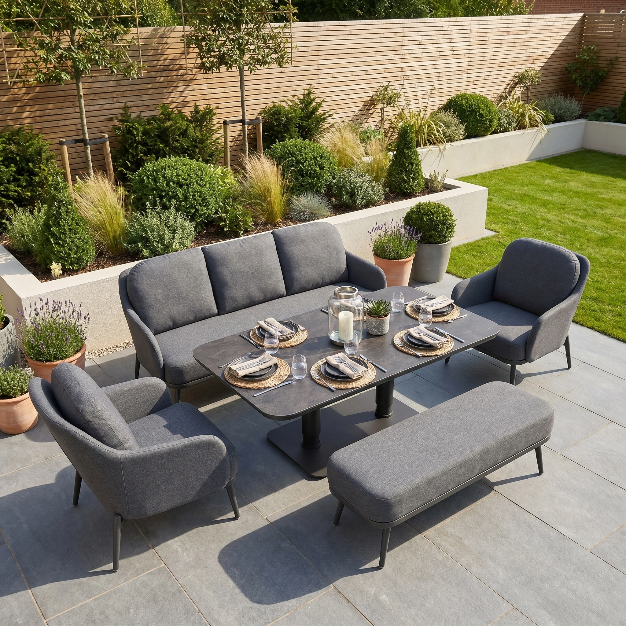 The Alva 3 Seat Sofa Dining Set with Rising Table in Grey offers cushioned seating for four and a stylish adjustable-height table, perfect for outdoor patio or garden spaces.