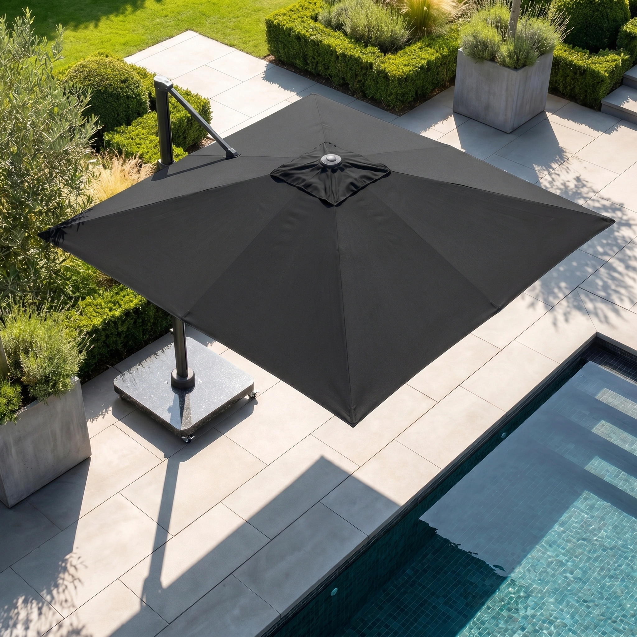 The Challenger T2 Premium 3.5m x 2.6m Rectangular Cantilever Parasol in Black offers stylish, premium shade for your poolside terrace or garden, ideal for modern outdoor living among lush plants and elegant landscaping.