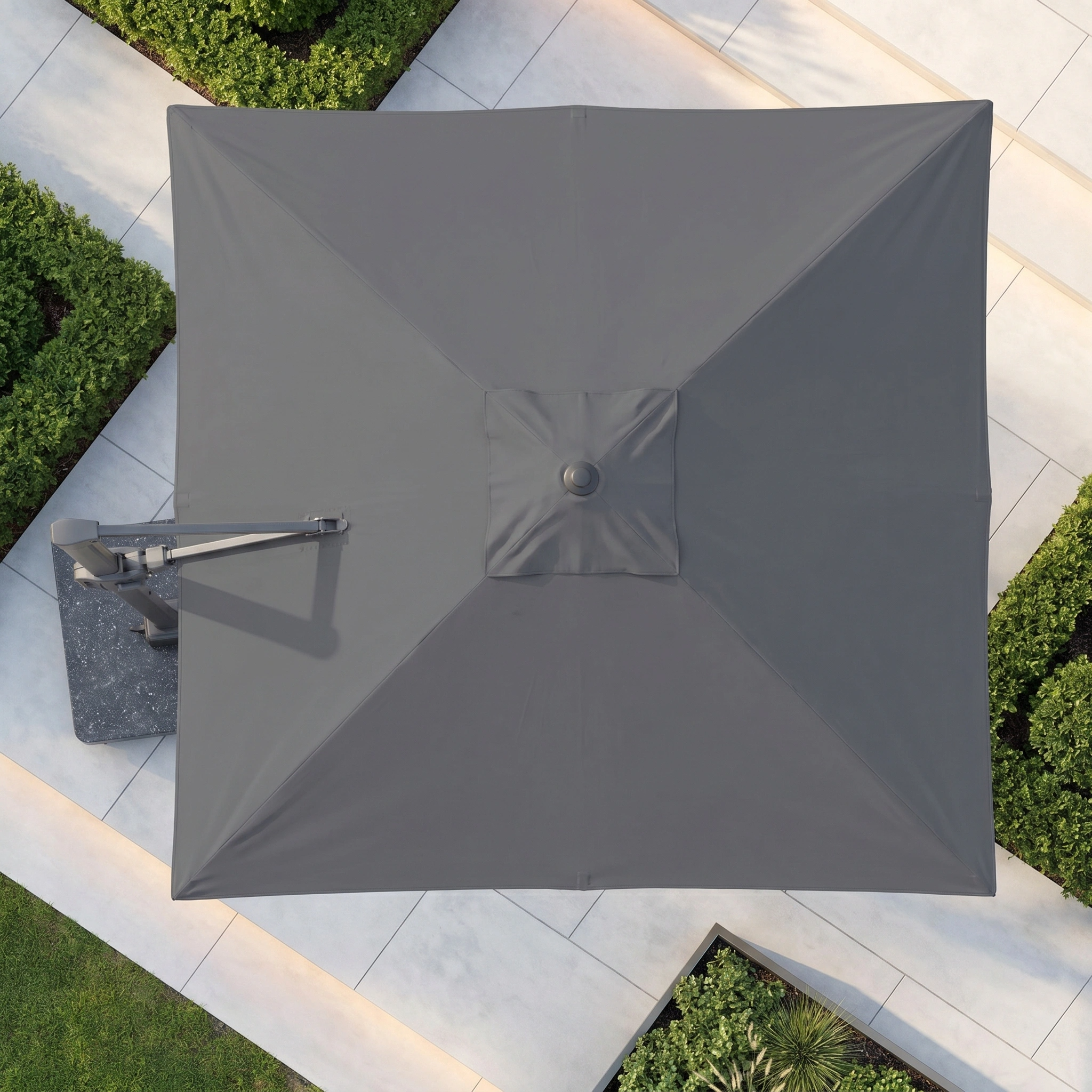 The Challenger T2 3.5m x 2.6m Rectangular Cantilever Parasol in Anthracite with 90kg Granite Base offers versatile shade and style for your outdoor space, pairing modern design with practical coverage amidst green hedges and stone tiles.