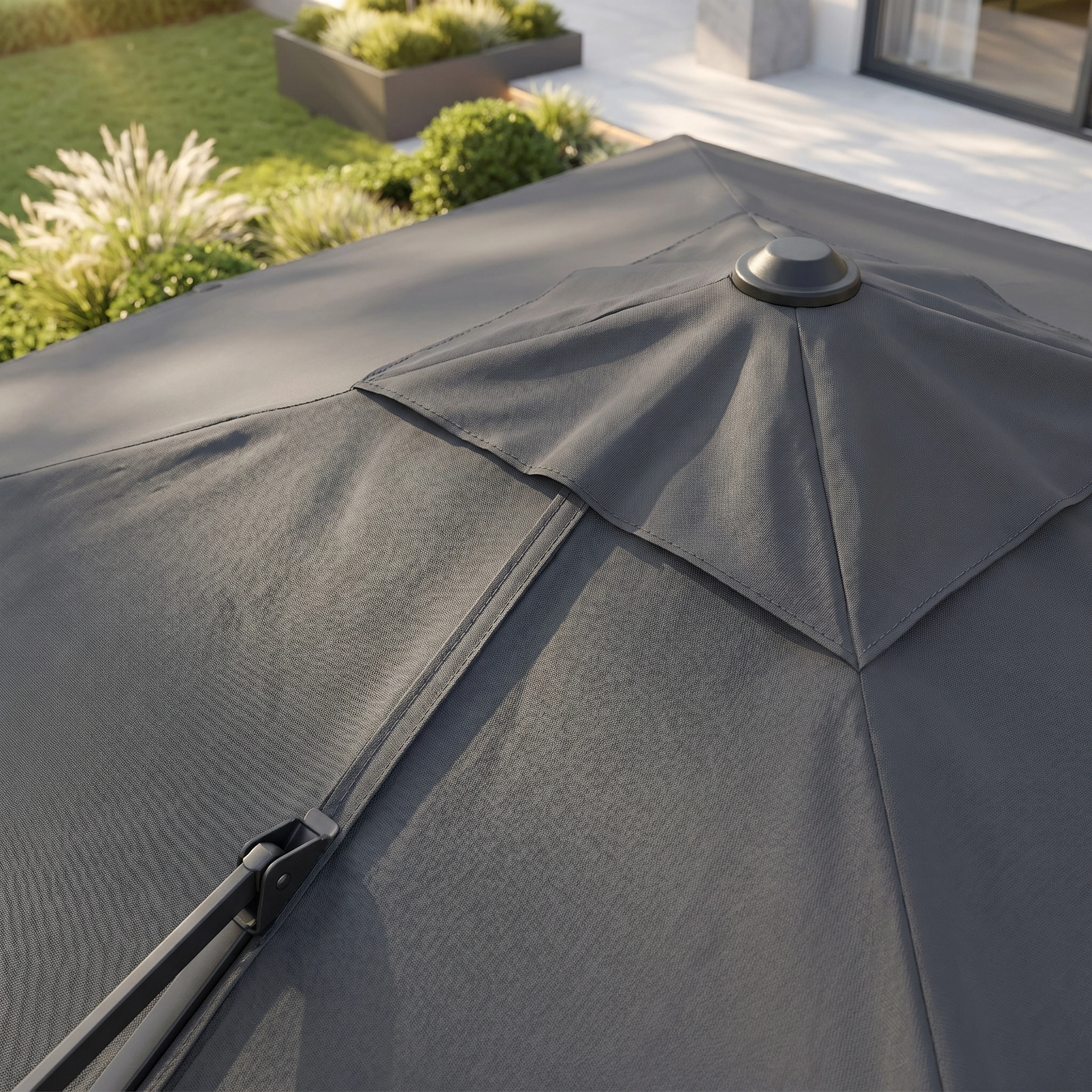 Close-up of the Challenger T2 3.5m x 2.6m rectangular cantilever parasol in anthracite with a 90kg granite base, set against a modern patio and garden backdrop.