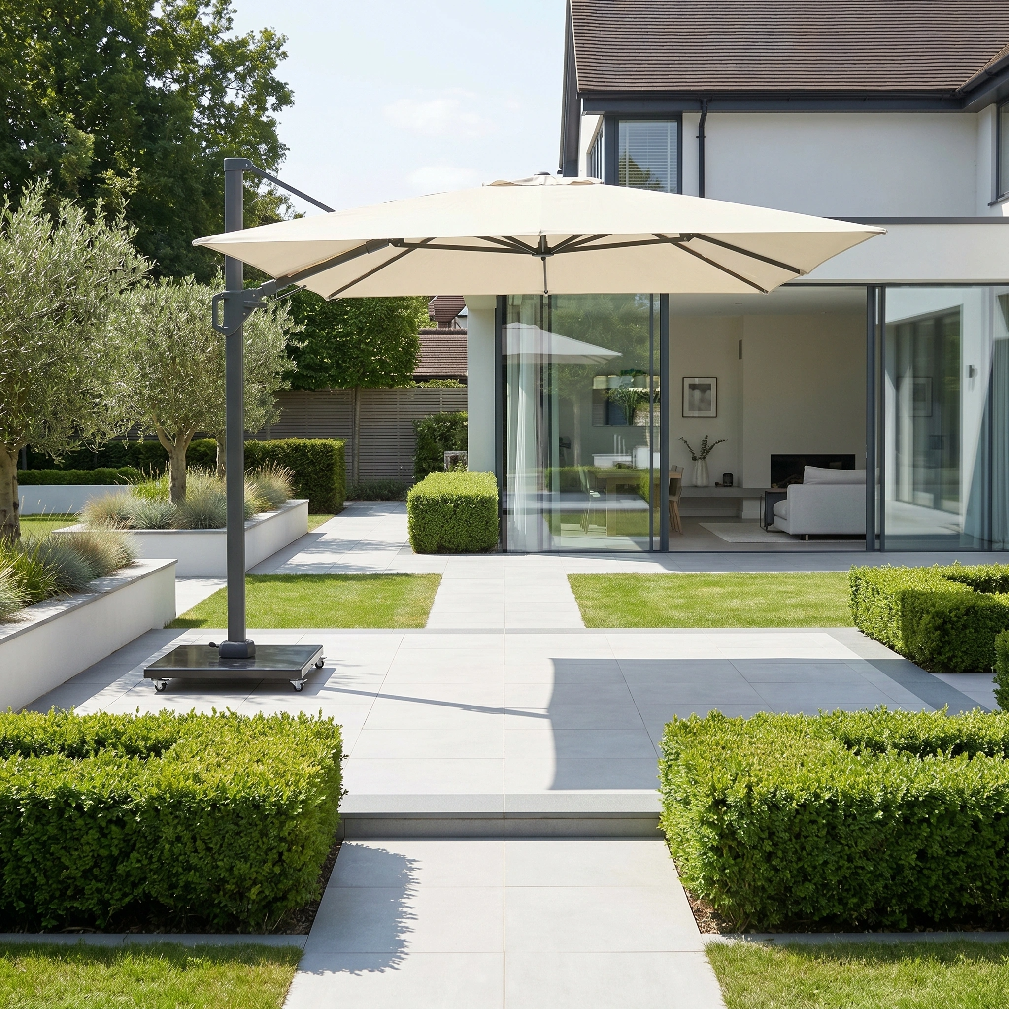 Modern house with large windows, manicured lawn, and neat hedges in the garden, complemented by a Challenger T2 3.5m x 2.6m Rectangular Cantilever Parasol in Champagne providing stylish patio shade.