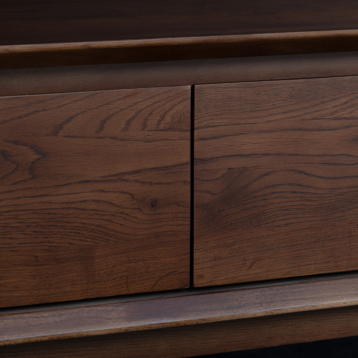 Close-up of a wooden drawer with visible wood grain and two panel fronts, reminiscent of the refined craftsmanship found in the Oslo Coffee Table with 4 Drawers in Walnut.
