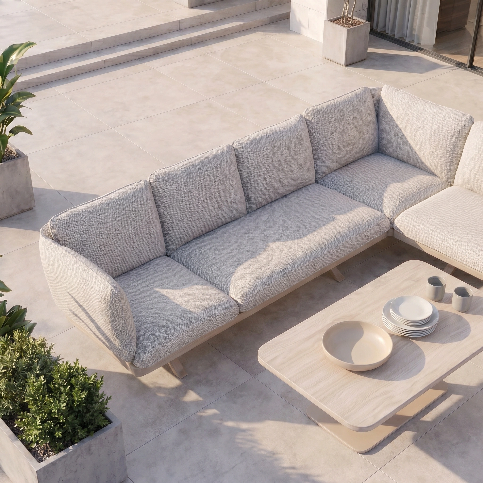 Modern outdoor patio featuring the Como Corner Sofa Set with Altura Rising Table in Oatmeal, plus potted plants on stone tile flooring—ideal for those seeking luxury outdoor furniture.