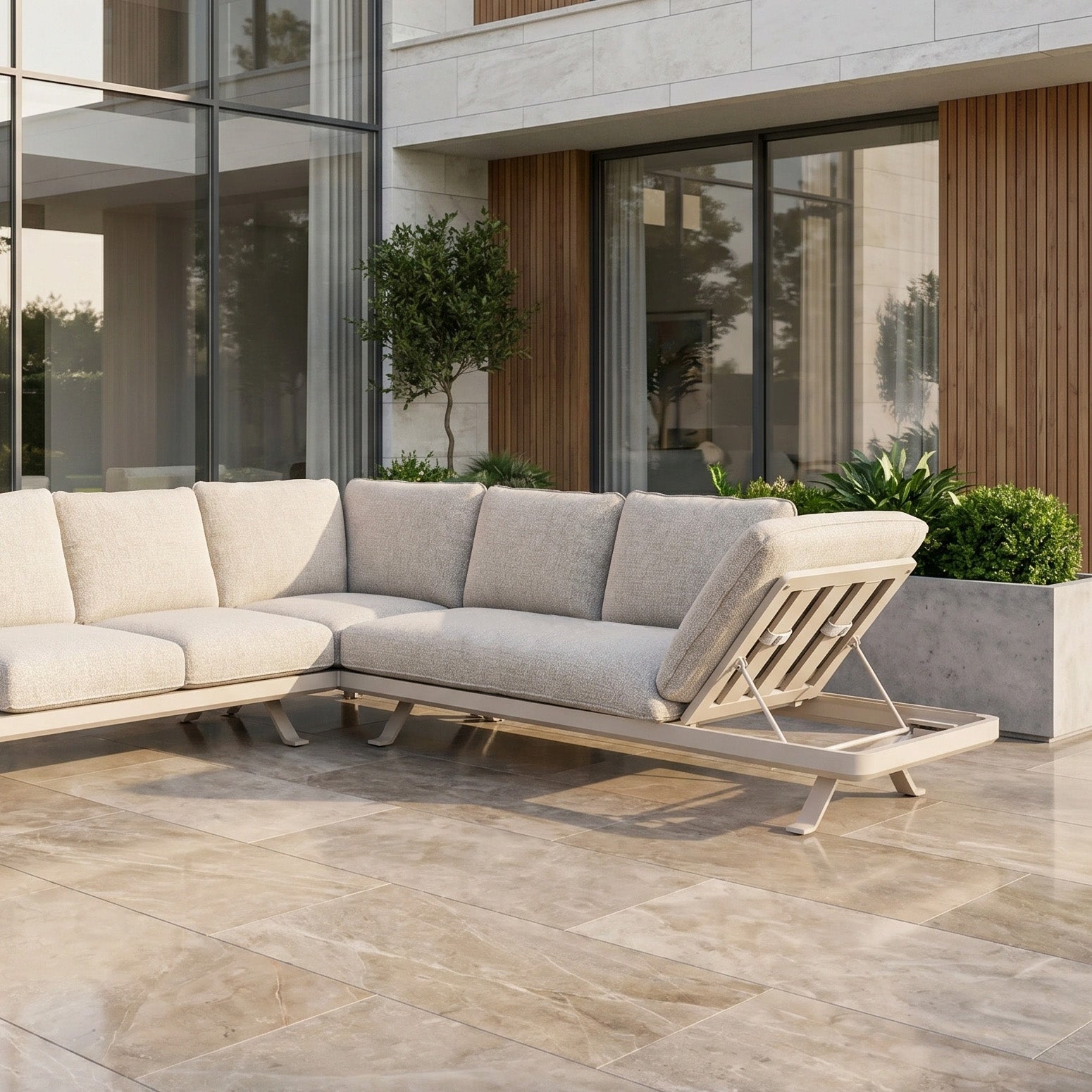 The Como Corner Sofa Set in Oatmeal, set on a tiled patio with lush plants and glass windows, creates an inviting atmosphere—perfectly showcasing outdoor luxury sofa design.