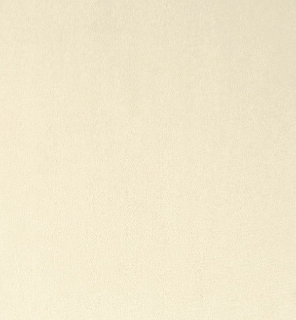 A plain beige texture with a subtle, grainy pattern evokes the quality craftsmanship of a Chesterfield Velvet Armchair in Cream handcrafted in England.