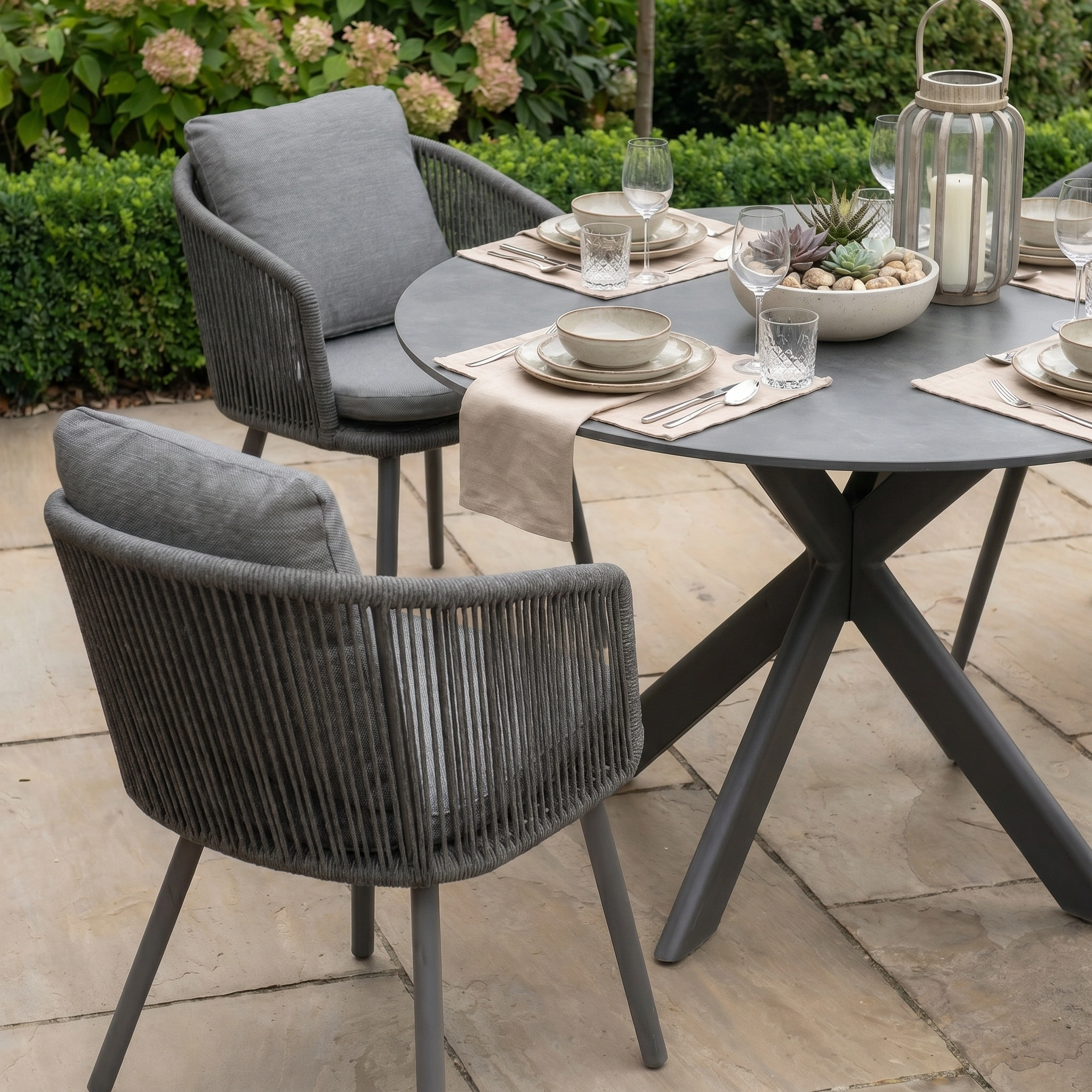 The Dekota 4 Seat Round Rope Dining Set with Albatross Table in Charcoal is perfect for relaxing alfresco meals, featuring stylish rope chairs and a modern round table—ideal outdoor dining furniture.