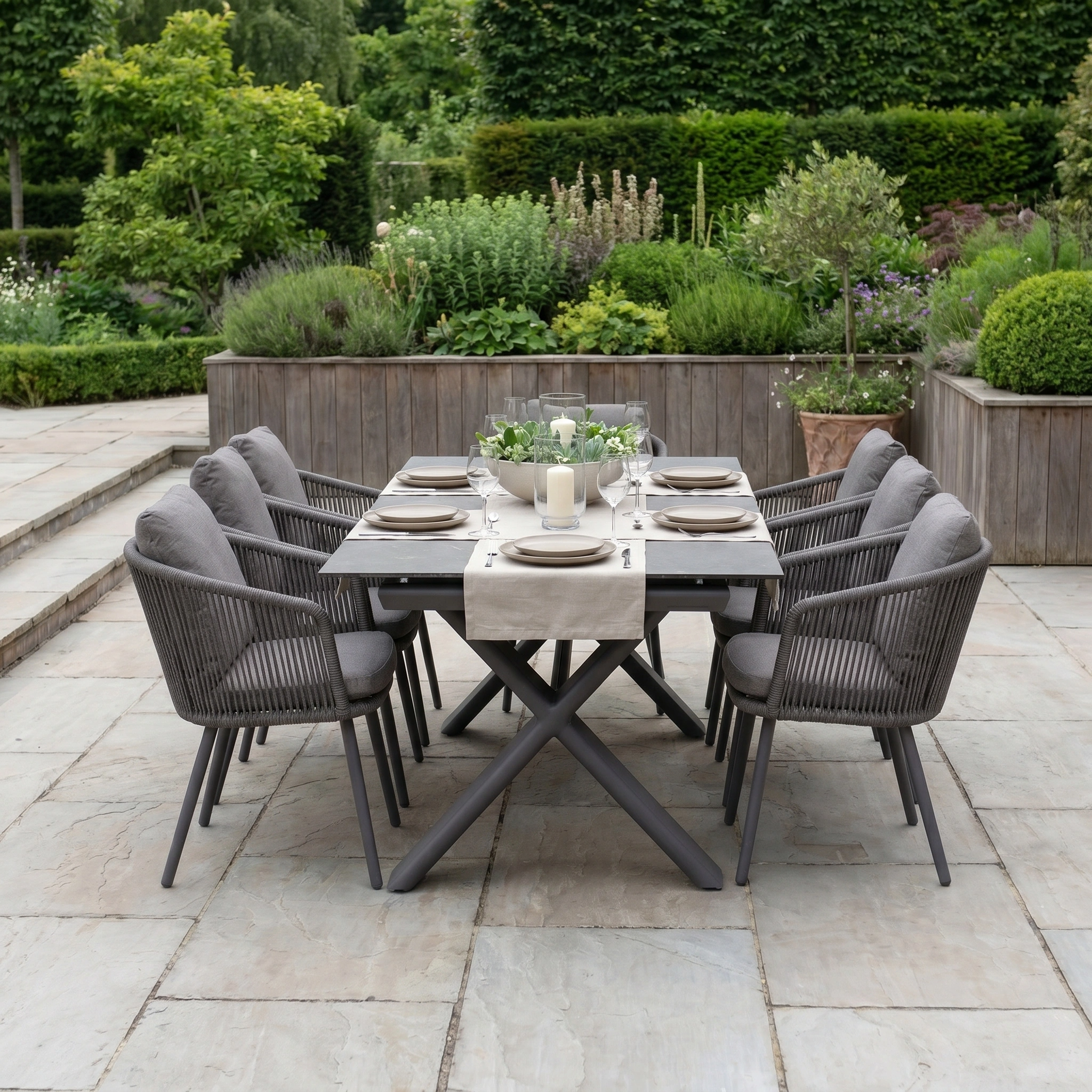 The Dekota 6 Seat Rope Dining Set with Albatross Extending Table in Charcoal is ideal for a stylish garden patio, featuring modern gray chairs—perfect for outdoor dining and entertaining.