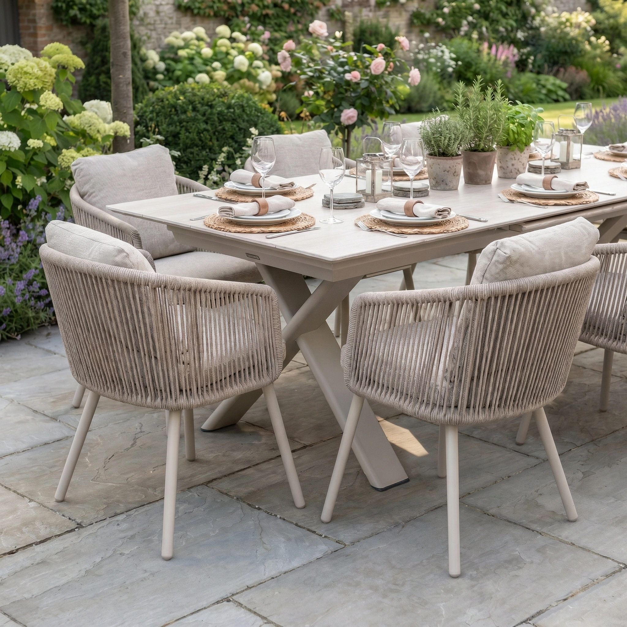 The Dekota 8 Seat Rope Dining Set with Albatross Extending Table in Fawn features scratch and UV-resistant aluminium, ideal for stylish garden dining. Includes eight cushioned chairs, perfect for outdoor meals among flowers and greenery.