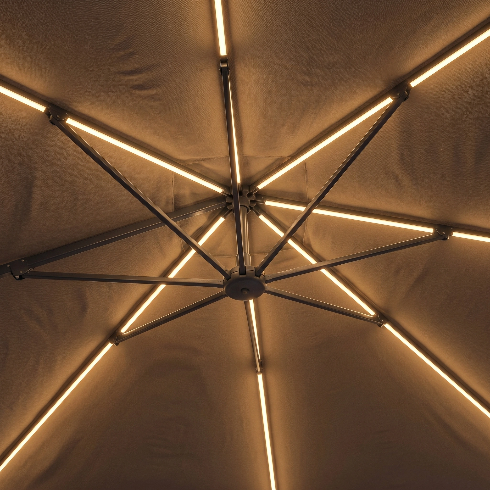 The Glow Challenger T2 3m Square Cantilever Parasol in Taupe, with a 90kg granite base, features warmly lit linear LED ribs and a sleek, durable powder-coated aluminium frame for style and elegance.