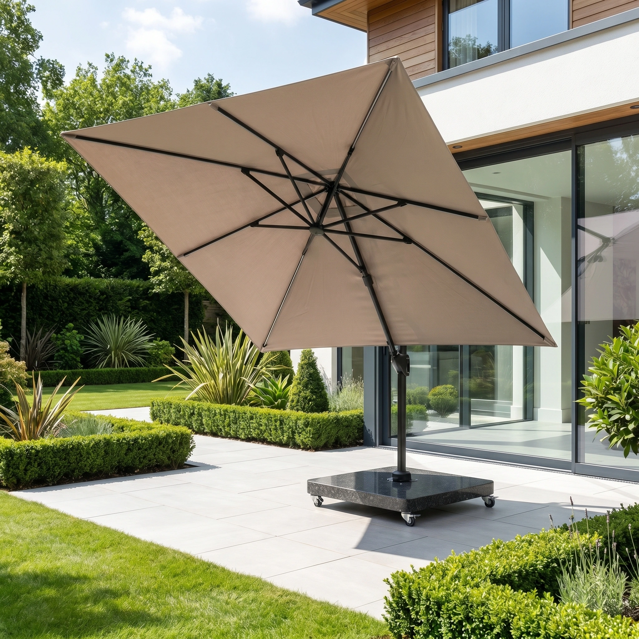 The Glow Challenger T2 3m Square Cantilever Parasol in Taupe with a 90kg granite base stands on a tiled terrace next to a modern home and landscaped garden.
