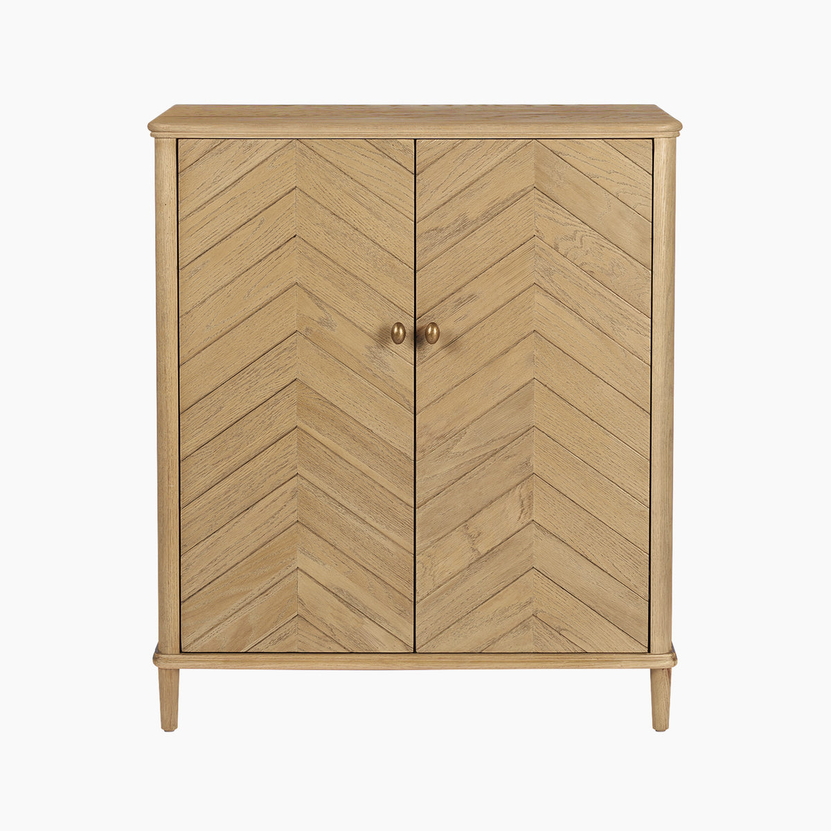 Introducing the Hadley Herringbone Drinks Cabinet in Natural: this elegant home bar cabinet showcases light oak wood with chevron-patterned doors and refined round handles, standing gracefully on four barrel legs against a crisp white backdrop. Add timeless sophistication to any space with this stunning natural oak drinks cabinet.