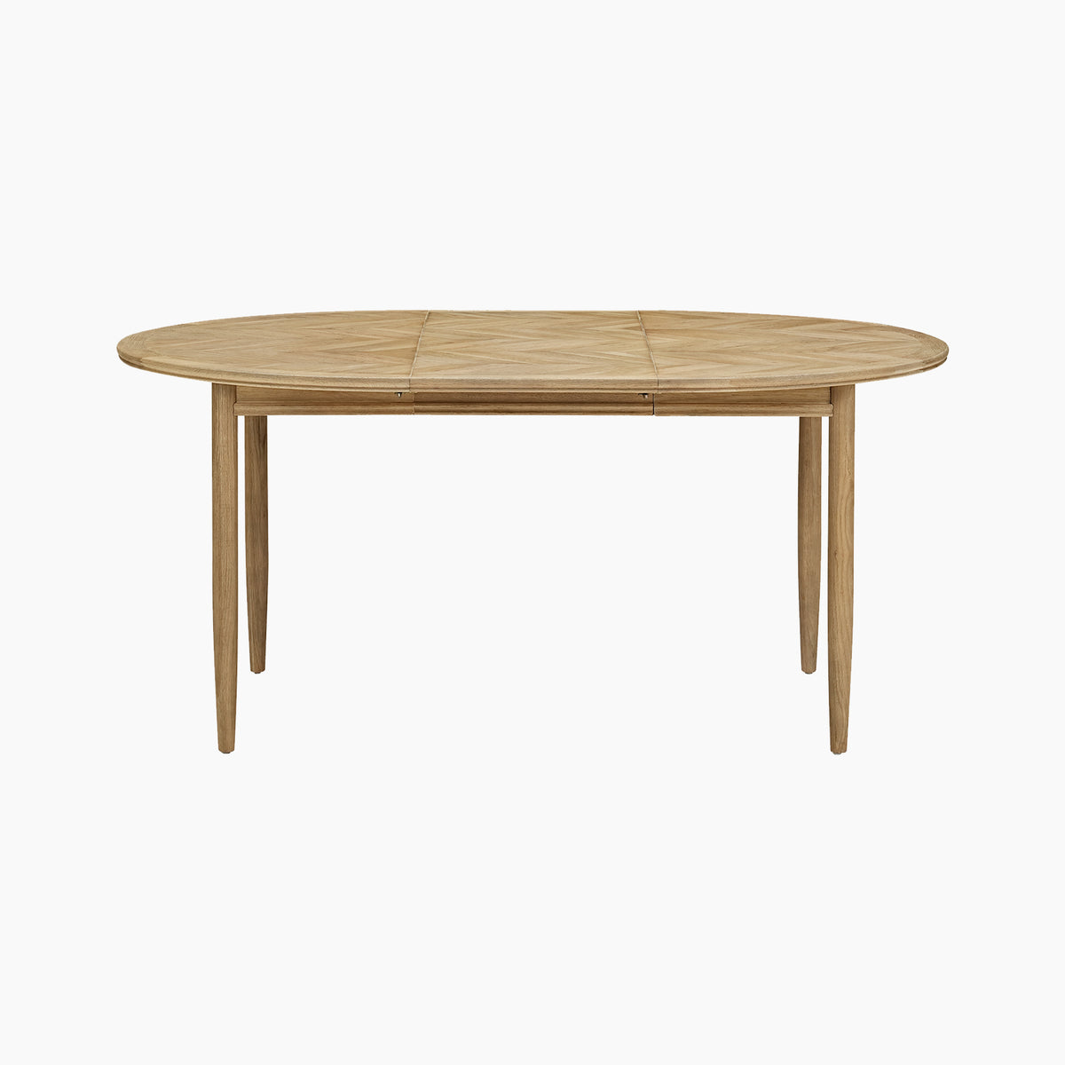 Shown against a plain white background, the Hadley Herringbone 4-6 Round Extending Dining Table in Natural features an elegant oval design with four barrel legs. Inspired by the classic charm of a traditional oak dining table, this piece blends timeless style with versatile functionality.