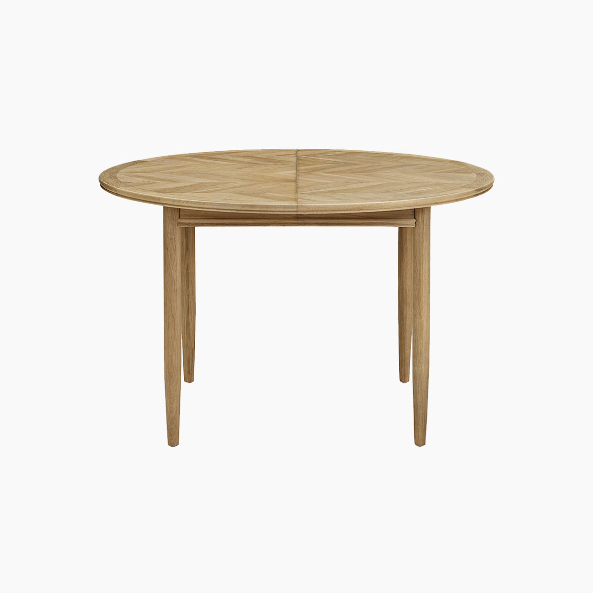 The Hadley Herringbone 4-6 Round Extending Dining Table in Natural features a light wood finish and four barrel legs, showcased against a plain white background. Inspired by timeless design, this versatile round dining table extends to accommodate more guests, making it perfect for modern gatherings.