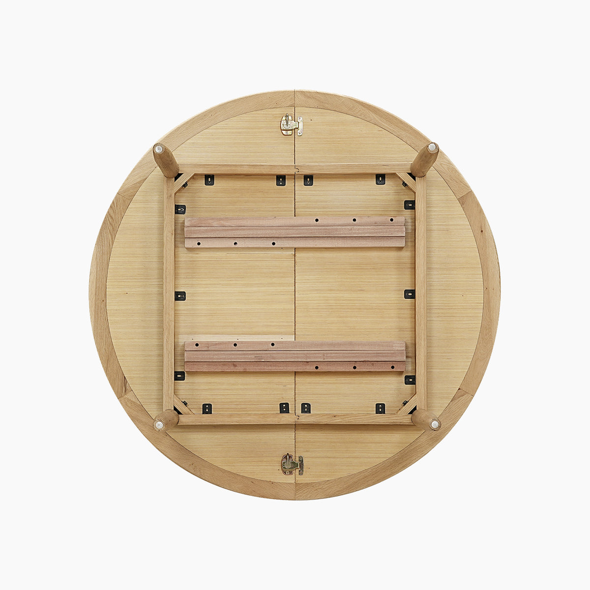 Round wooden table flipped upside down, displaying folded legs and sturdy metal hinges on a white background. This piece is reminiscent of the Hadley Herringbone 4-6 Round Extending Dining Table in Natural, featuring practical extending design elements and reliable metal hinges for effortless transformation.
