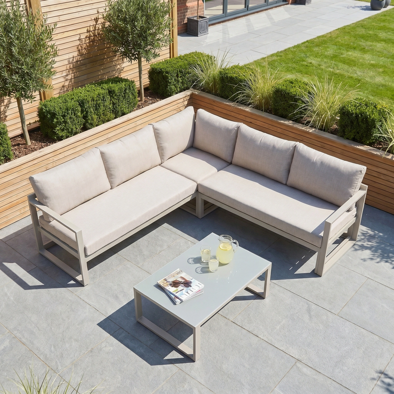 The Havana Corner Group Set in Latte includes a reclining corner sofa with light cushions and a glass-topped coffee table, making it perfect for your patio.