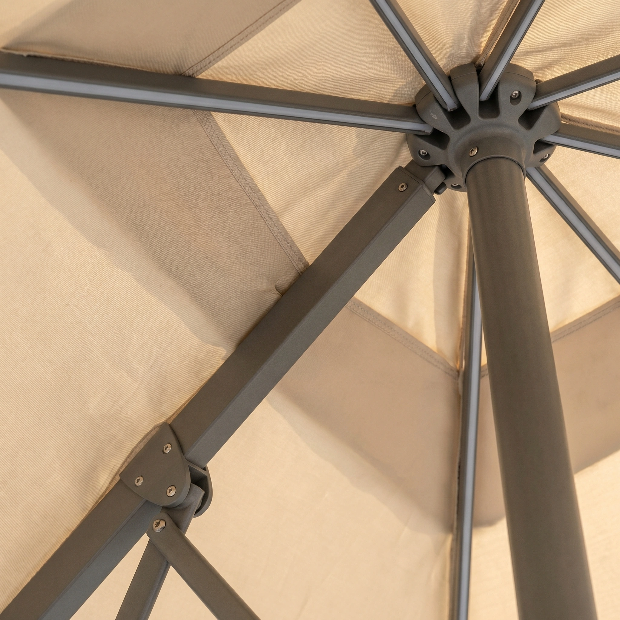 Close-up of the underside of the Hera 2.7m Square Cantilever Parasol with LED Lighting in Beige, showcasing its sturdy metal frame and spokes, plus UV50+ sun protection for durable outdoor comfort.