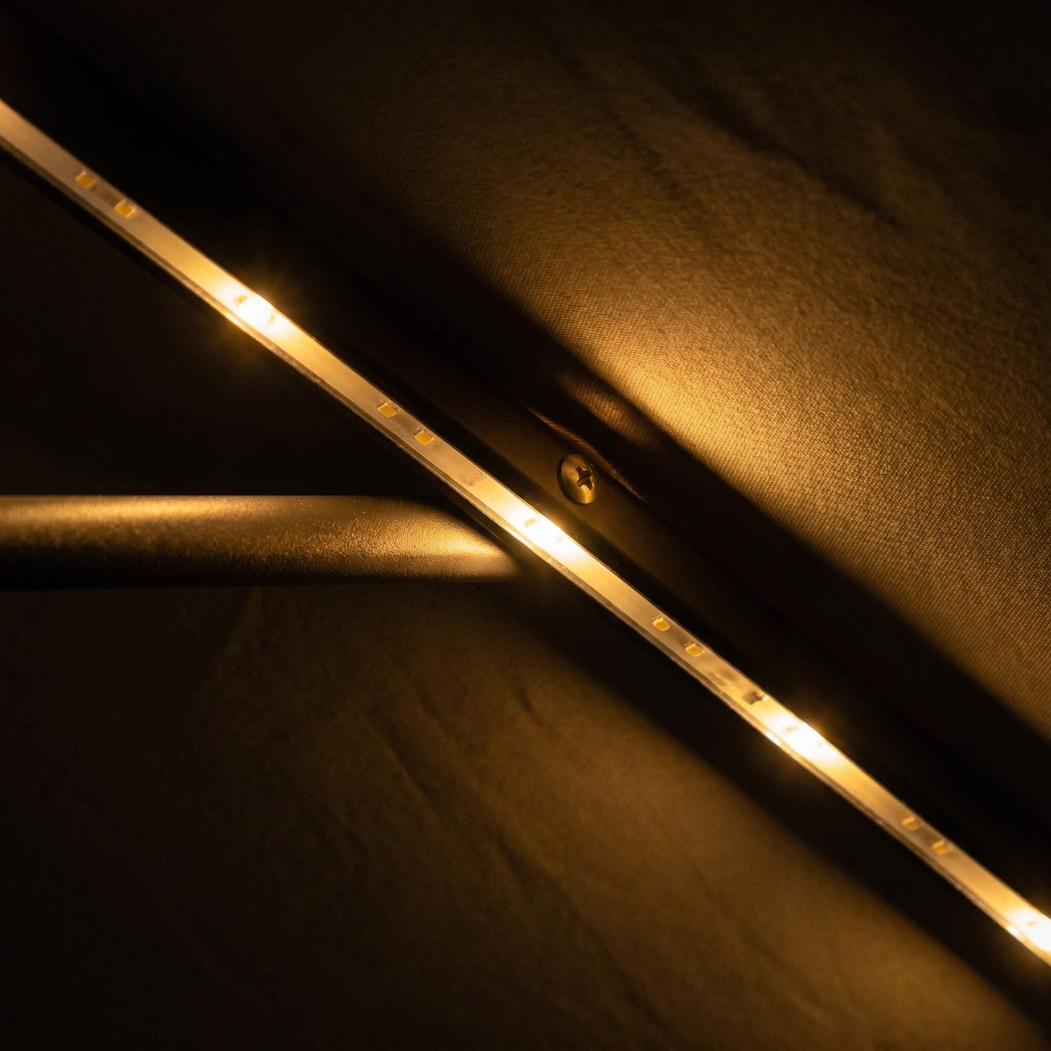 Close-up of warm LED strip lights on the Hera 3m x 2m Rectangular Cantilever Parasol with LED Lighting in Beige, casting a soft glow—ideal ambient lighting under your UV protection outdoor umbrella.