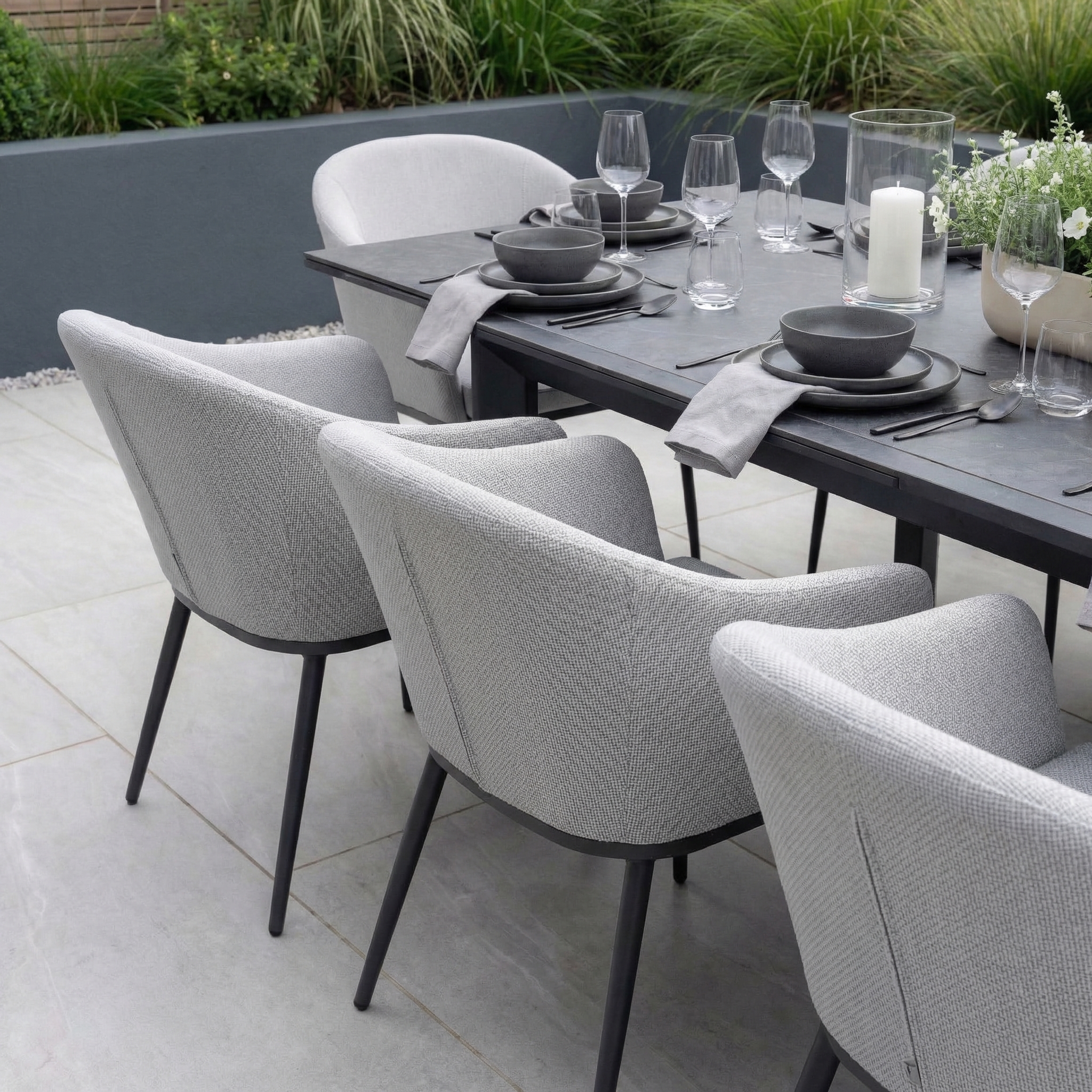 The Luna 10 Seat Outdoor Fabric Extending Ceramic Dining Set in Oyster Grey features grey cushioned chairs and is ideal for stylish, all-weather outdoor dining.