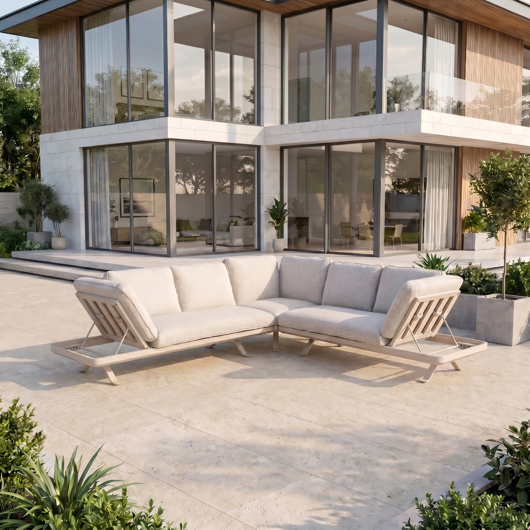 Modern outdoor patio featuring the Como Corner Sofa Set in Oatmeal, placed before a contemporary glass-walled house and lush greenery, exemplifying stylish modular outdoor furniture.