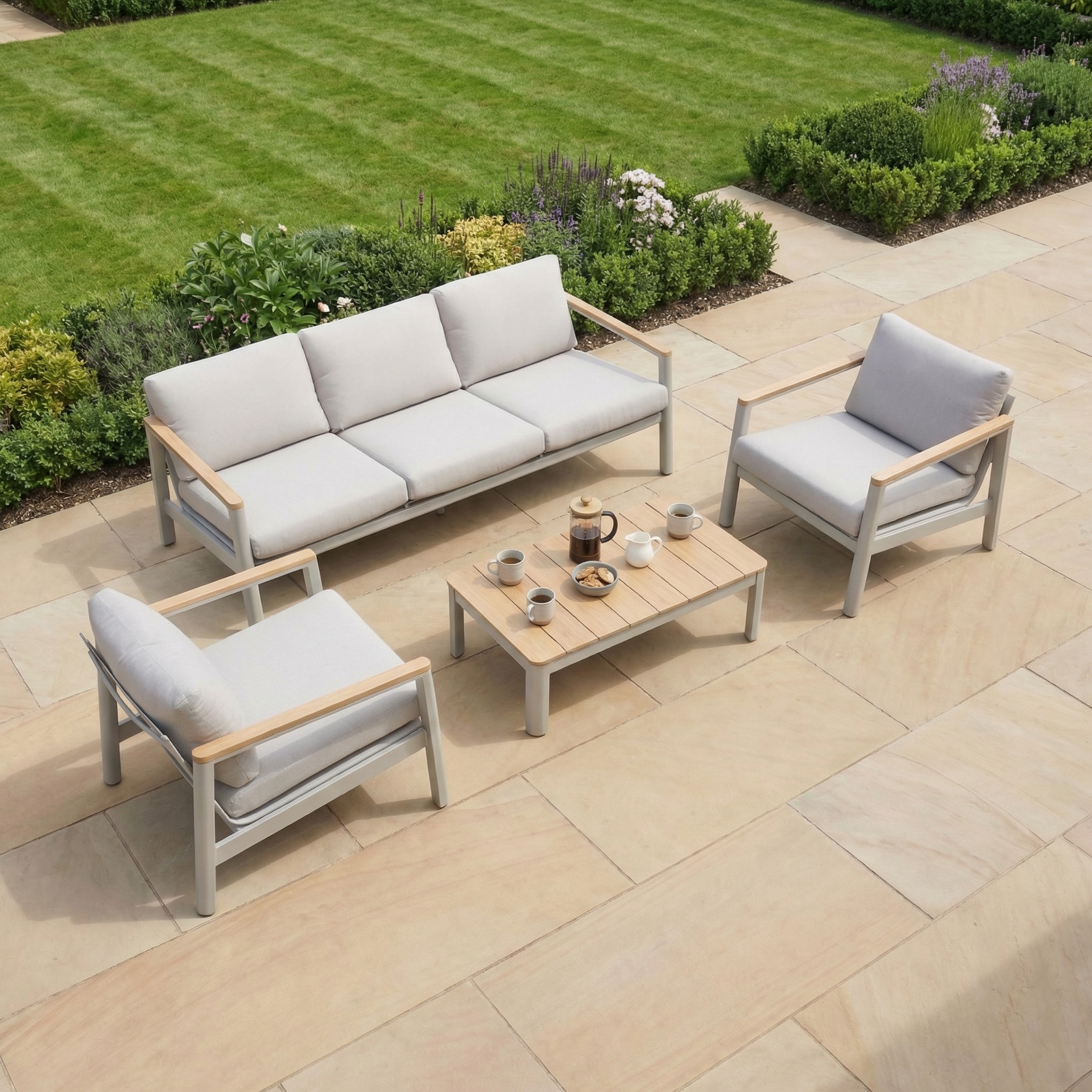 The Cora 3 Seat Sofa Set in Latte features cushioned chairs and an aluminium frame, complete with a coffee table, ideal for outdoor stone terraces by the lawn.