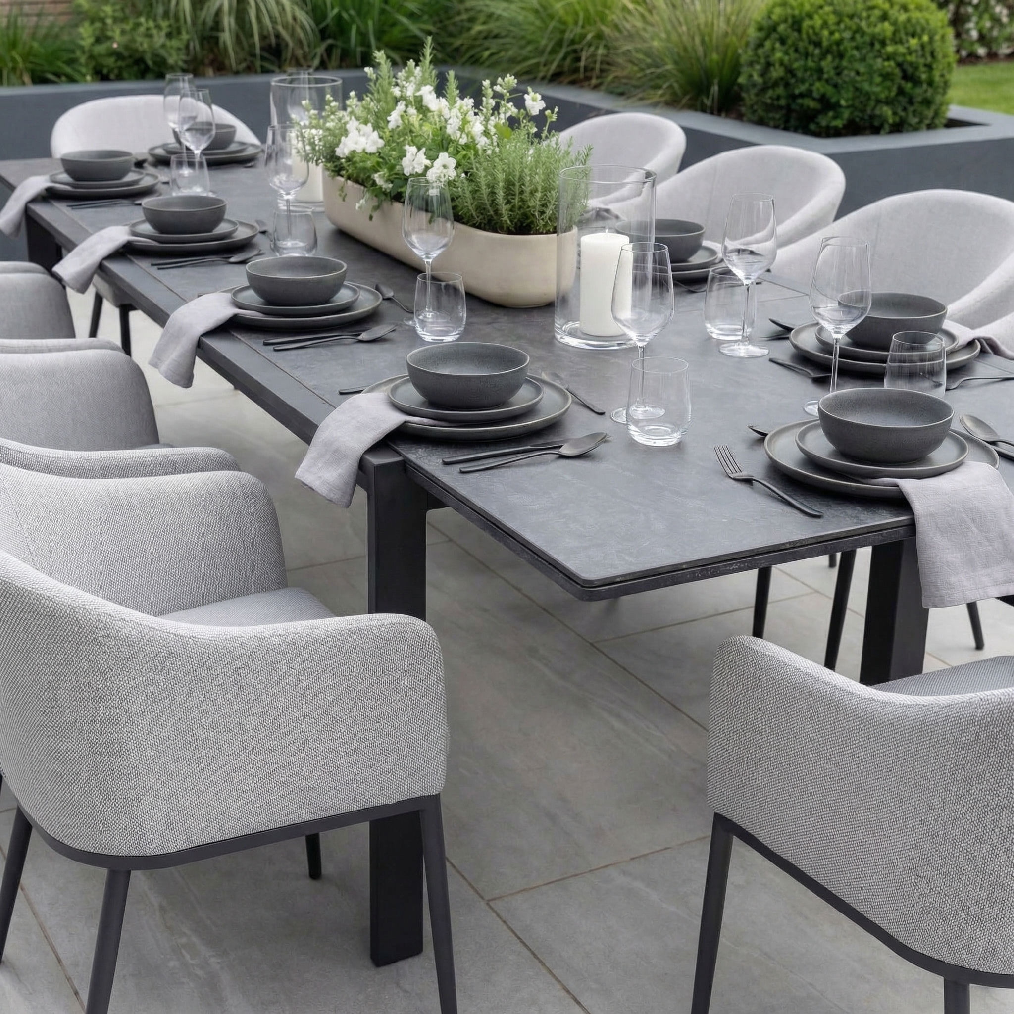 The Luna 10 Seat Outdoor Fabric Extending Ceramic Dining Set in Oyster Grey seats ten and features a stylish design—ideal for outdoor gatherings with family and friends.