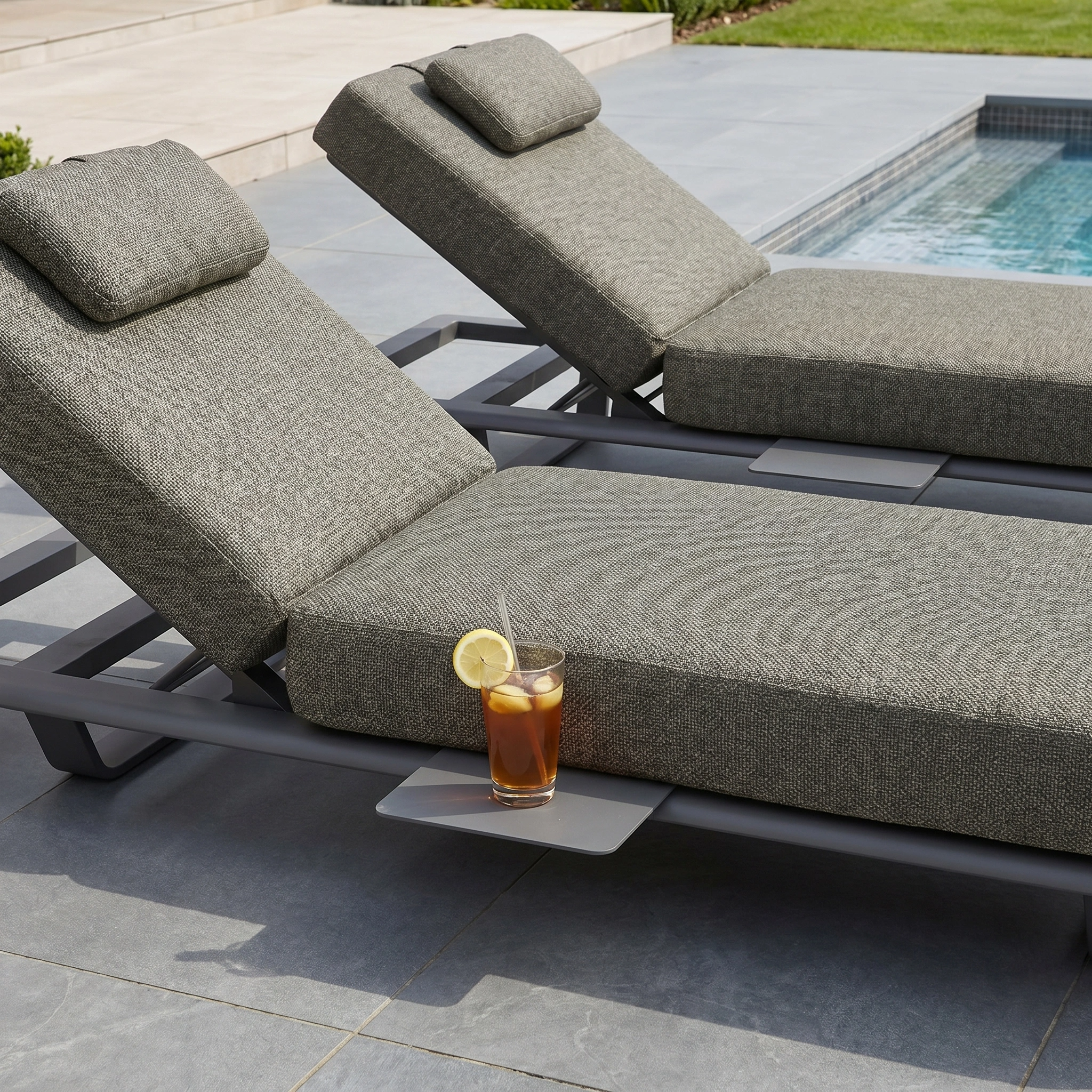The Hatia Single Sun Lounger with Side Table in Charcoal is ideal poolside outdoor furniture—perfect for sunbathing and relaxing with your favorite drink.