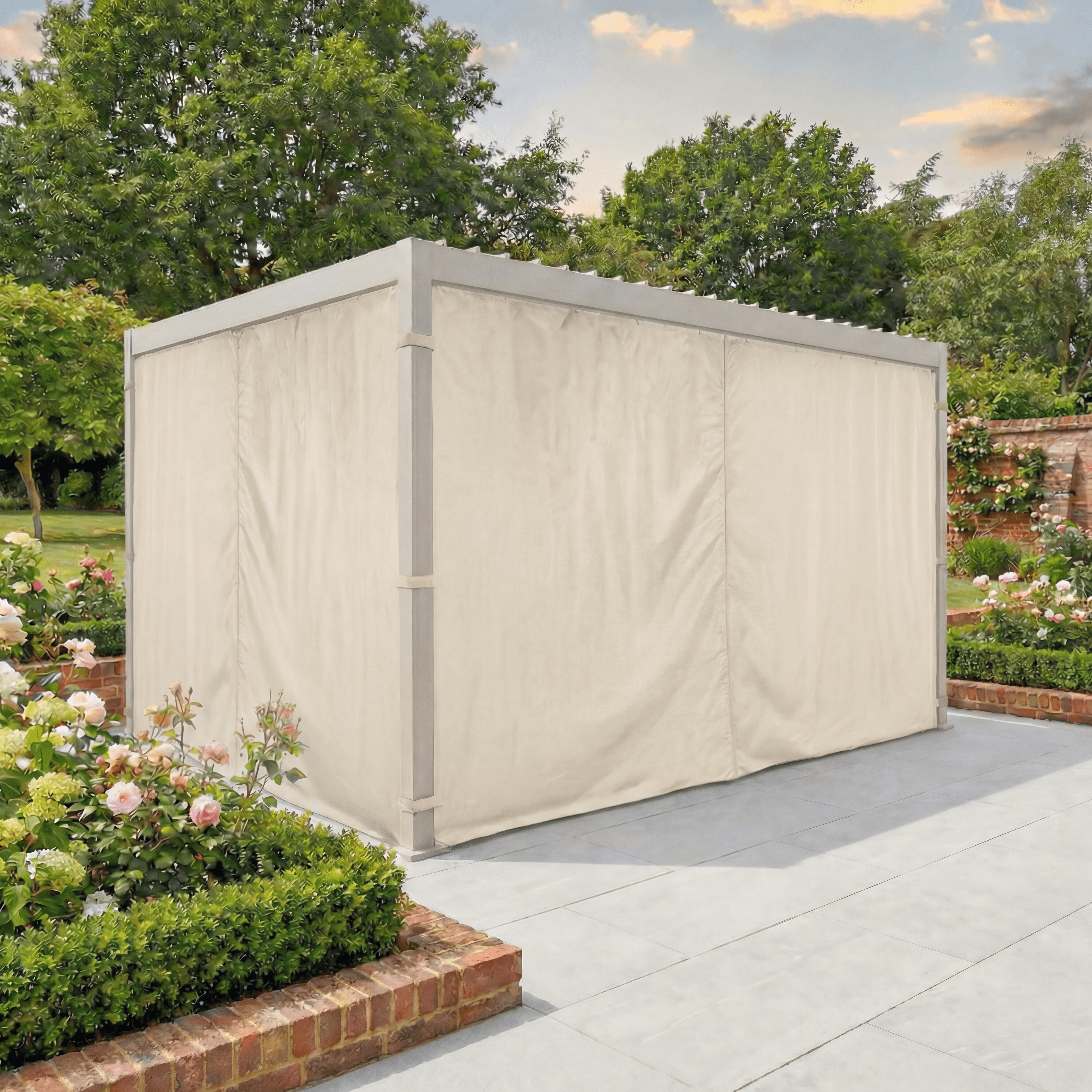 PergoSTET Side Curtains for Lite and Lite Neo 3m x 4m Rectangular Pergola in Latte add weather-resistant style to a garden pergola on a stone patio surrounded by roses and lush greenery.