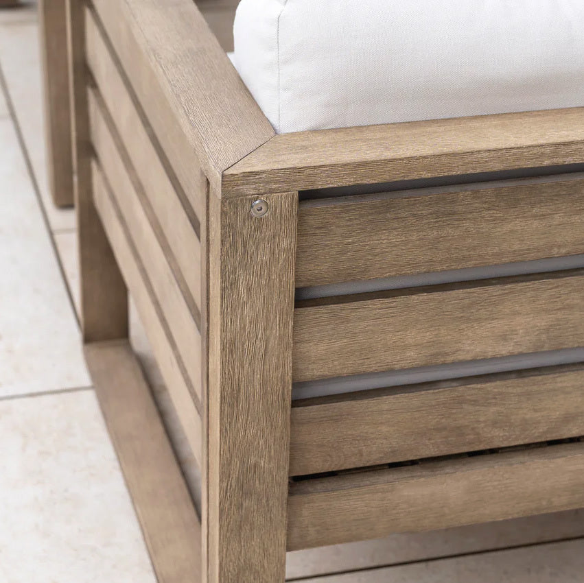 Close-up of the Andora Large Corner Sofa Set with 2 in 1 Table in Weathered Brown, featuring modular wooden seating with white cushions on a tiled floor.