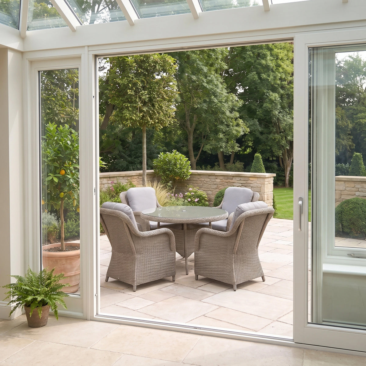 a glass door to a patio with chairs and a table