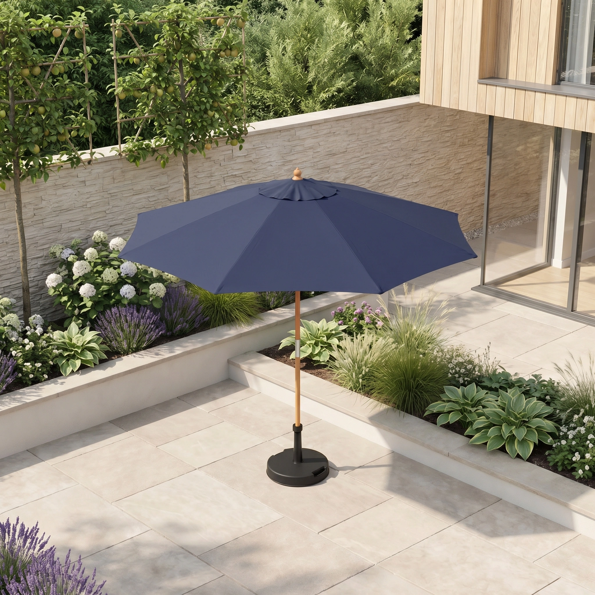 The Kratos 2.5m Round Wooden Parasol in Navy stands on a tiled terrace amid green plants and modern landscaping, offering stylish UV 50+ sun protection.
