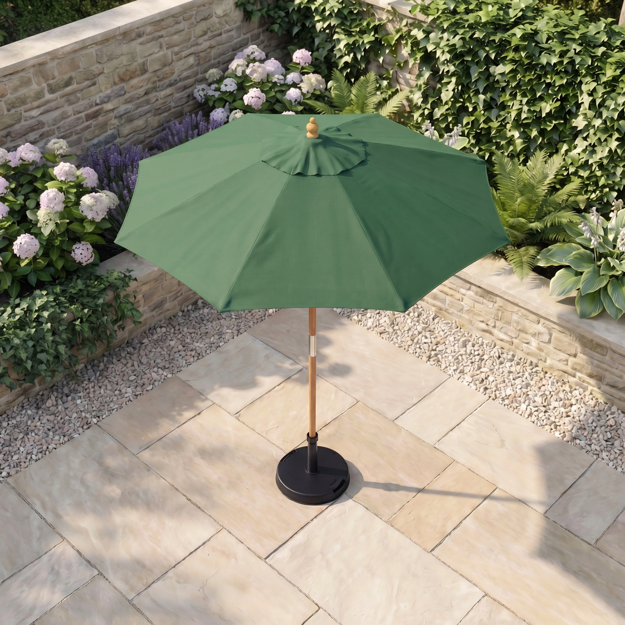 The Kratos 2m Round Wooden Parasol in Green provides shade over a stone-tiled patio, bordered by vibrant garden plants and flowers.