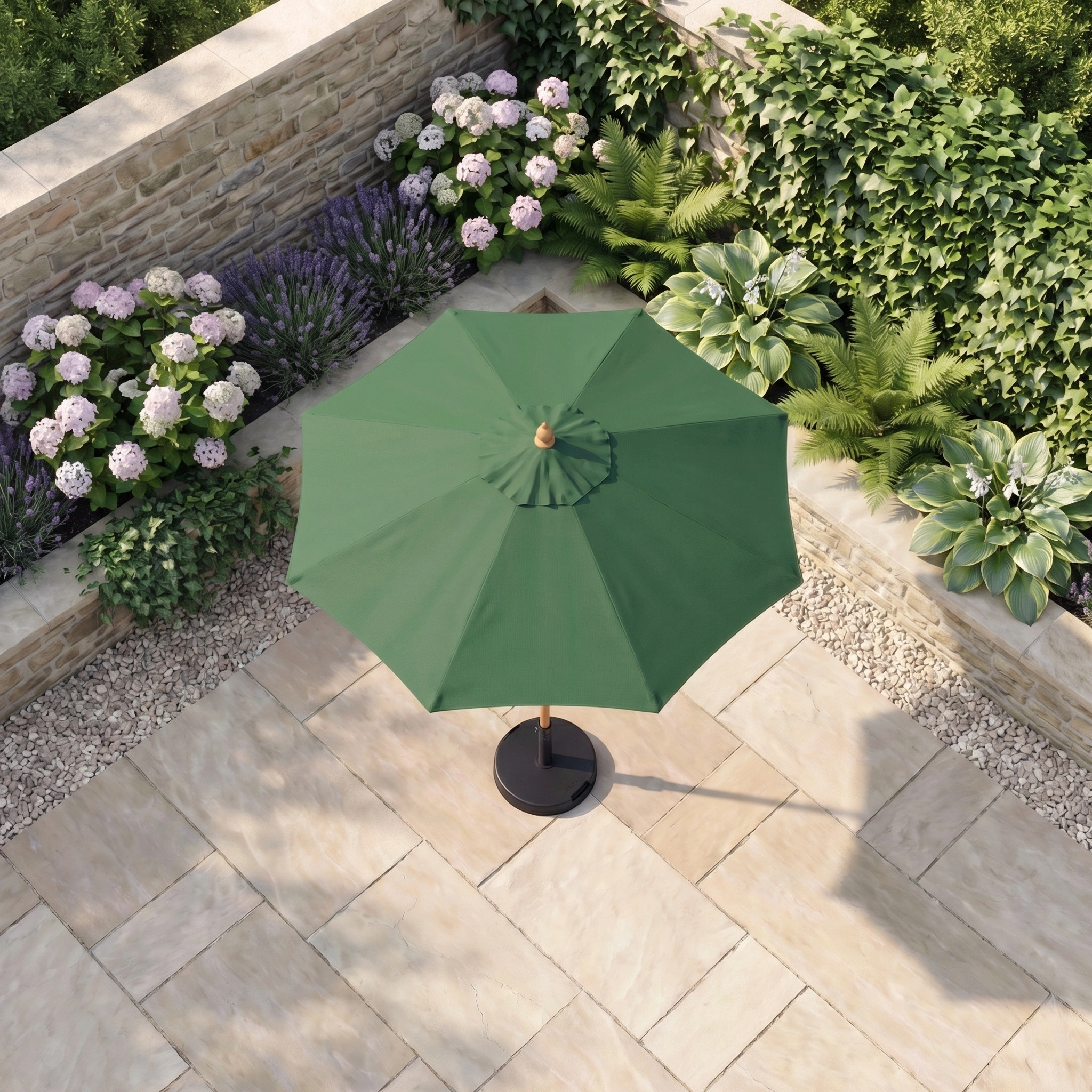 The Kratos 2m Round Wooden Parasol in Green stands on a stone terrace, surrounded by lush plants and blooming flowers near a stone wall, creating a peaceful outdoor retreat.