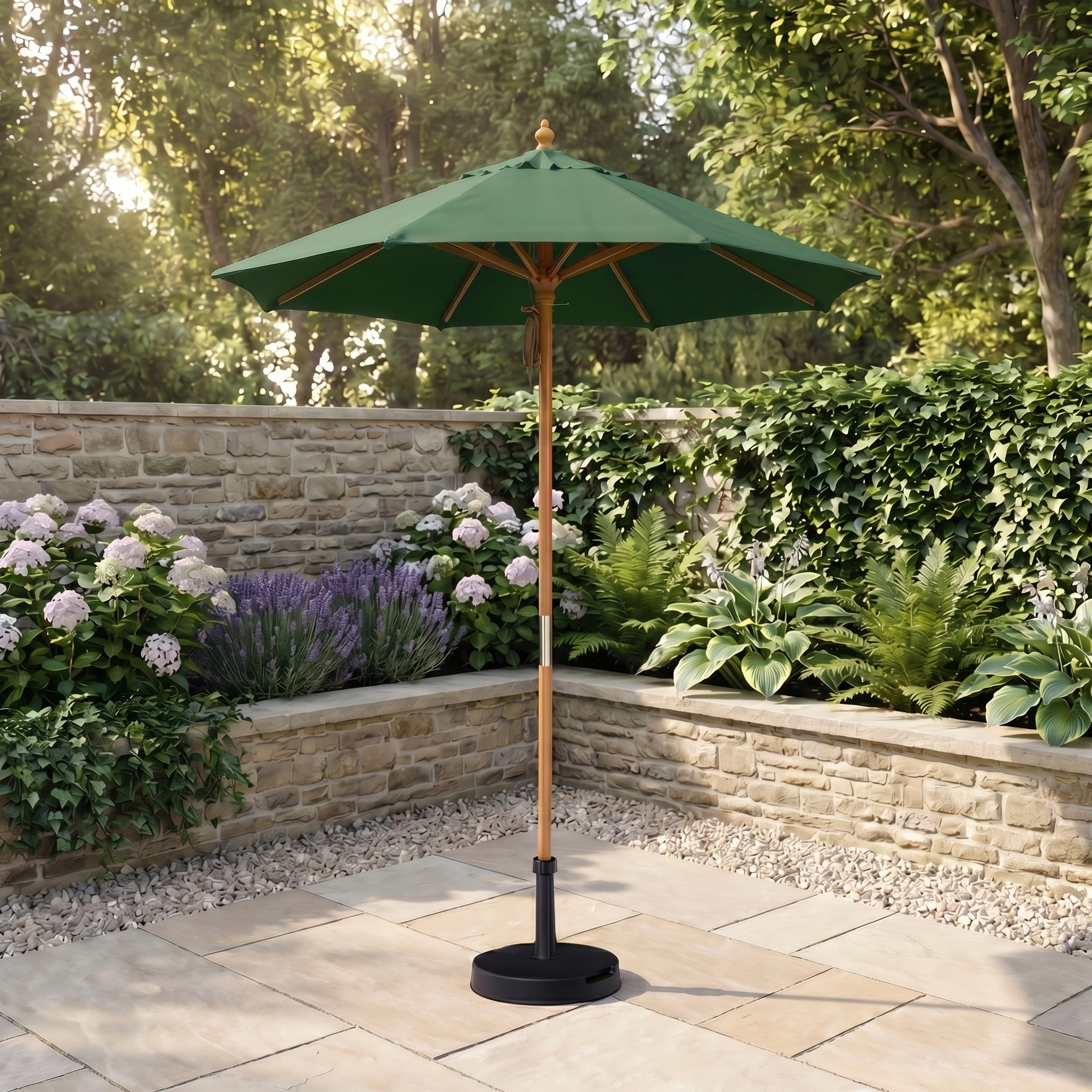 The Kratos 2m Round Wooden Parasol in Green stands in a sunny garden with stone walls, flowers, and leafy plants, creating the perfect relaxing spot.