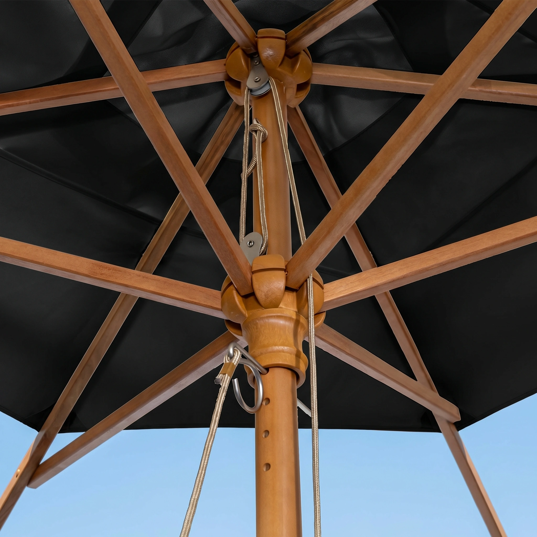 Close-up of the Kratos 3m x 2m Rectangular Wooden Parasol in Black, featuring a sturdy wooden frame and support ribs, UV 50+ protection, shown against a vivid blue sky.