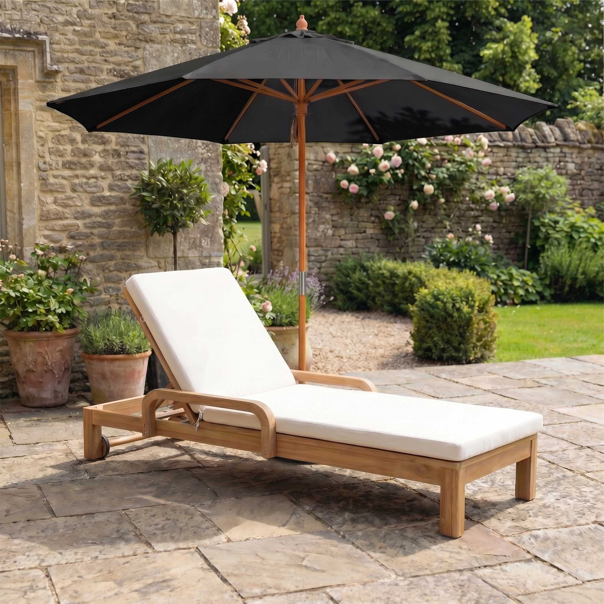 Wooden lounge chair with white cushion under the Kratos 3m Round Wooden Parasol in Black on a stone patio, providing stylish shade and UV protection in the garden.