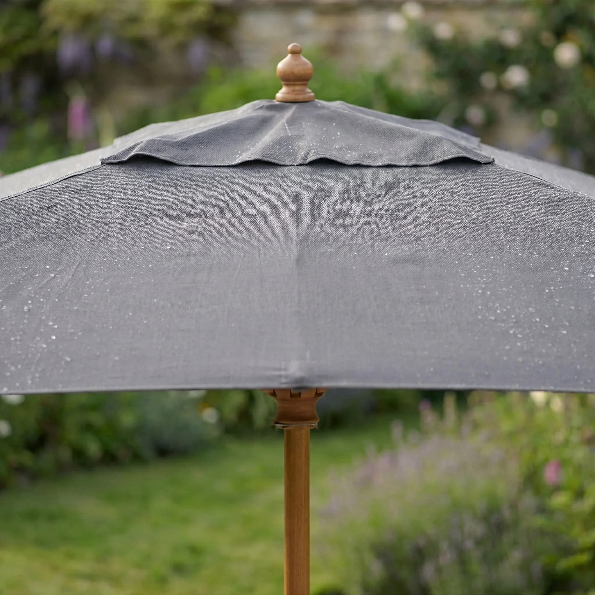 The Kratos 3m x 2m Rectangular Wooden Parasol in Grey features a wooden pole and a water-resistant canopy, providing stylish sun protection with a chic touch of grey.
