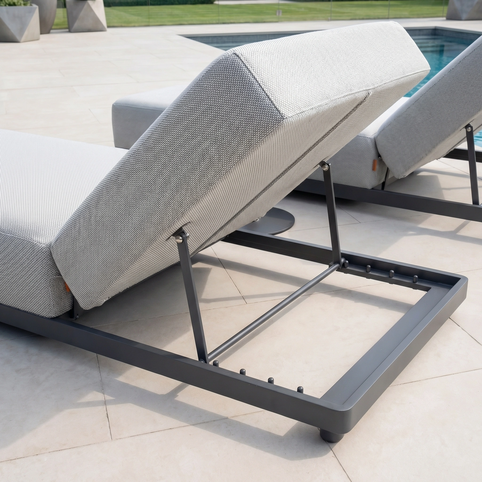 The Luna Outdoor Fabric Deluxe Sun Lounger in Oyster Grey offers stylish, durable comfort on the patio beside the pool—perfect as modern garden furniture.
