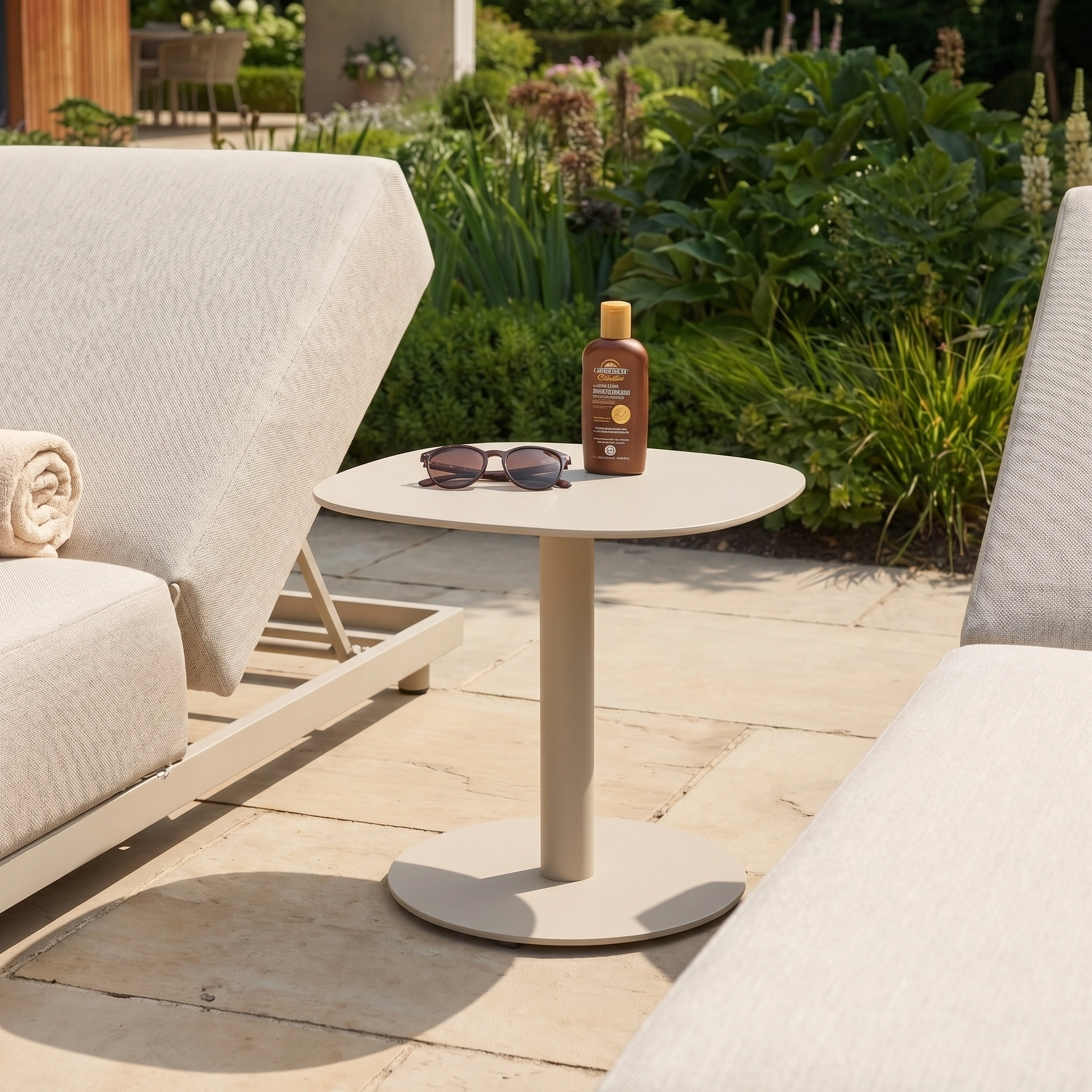 The Luna Side Table in Latte (45cm x 45cm), weatherproof and compact, sits between all-weather fabric patio chairs, topped with sunglasses and sunscreen, on a sunny terrace.